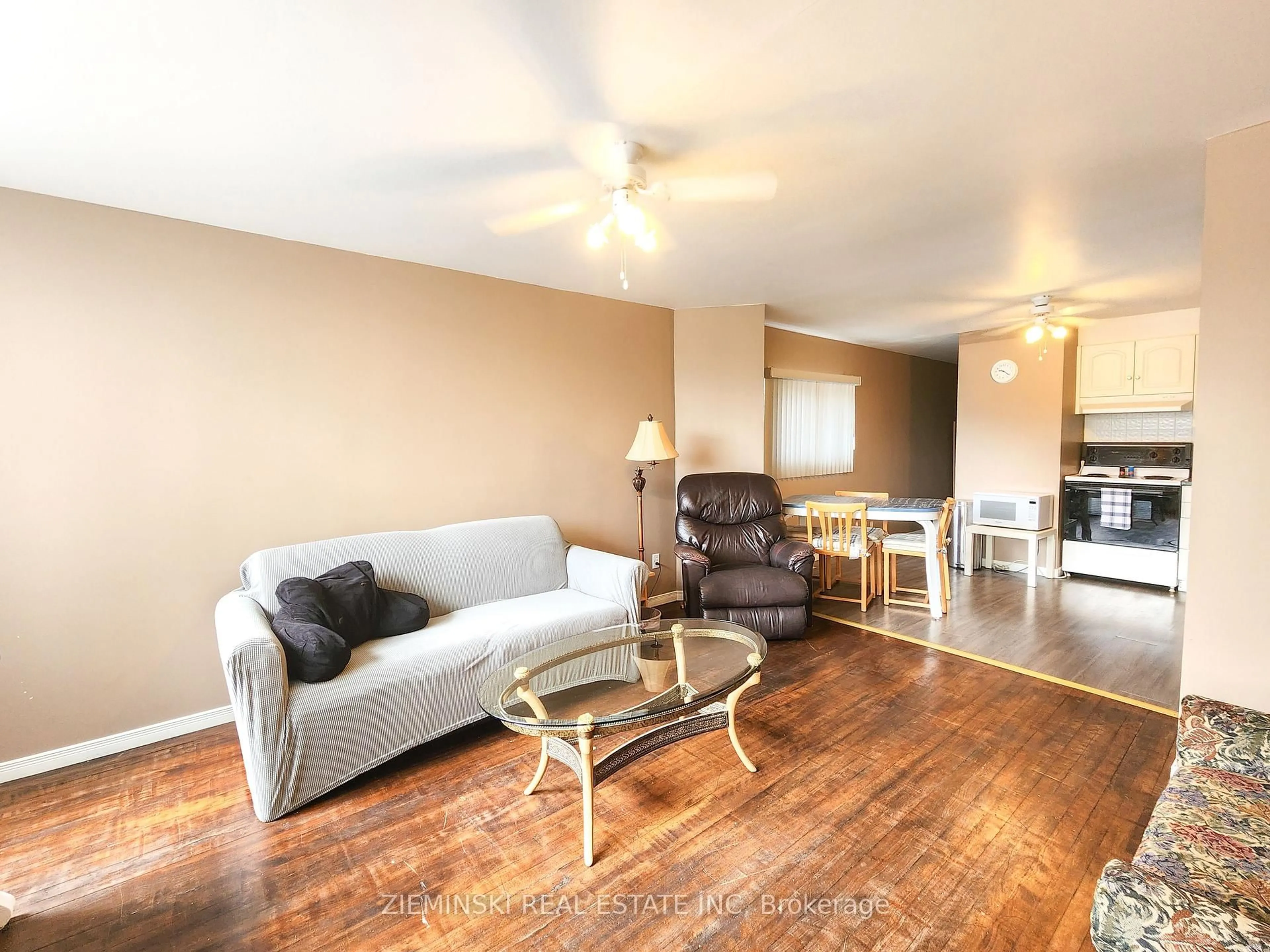 Living room with furniture, wood/laminate floor for 7 Boisvert St, Kirkland Lake Ontario P0K 1T0
