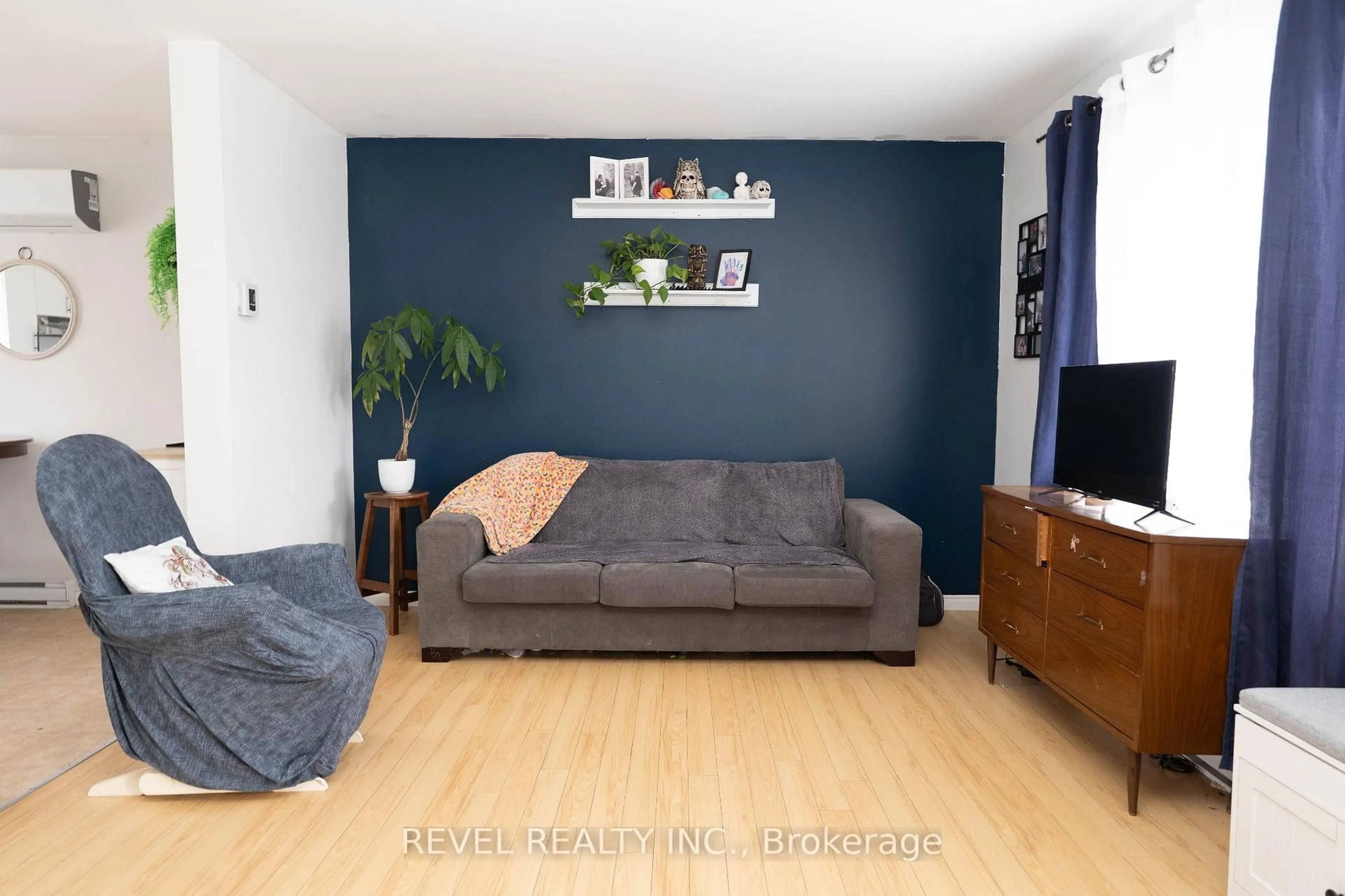 Living room with furniture, wood/laminate floor for 11 Fifth St, Cochrane Ontario P0L 1C0