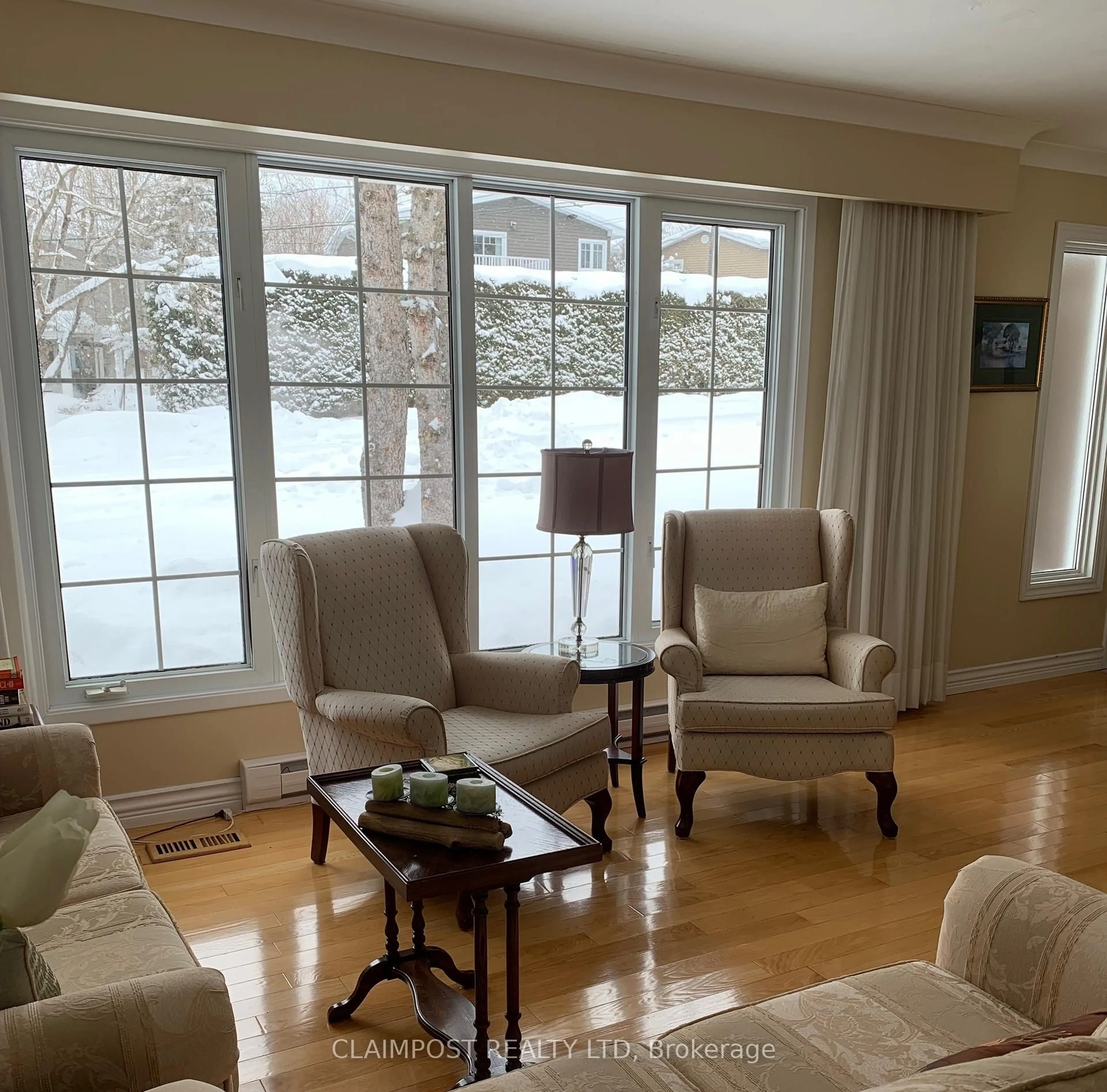 Living room with furniture, wood/laminate floor for 670 Spruce St, Timmins Ontario P4N 6P3