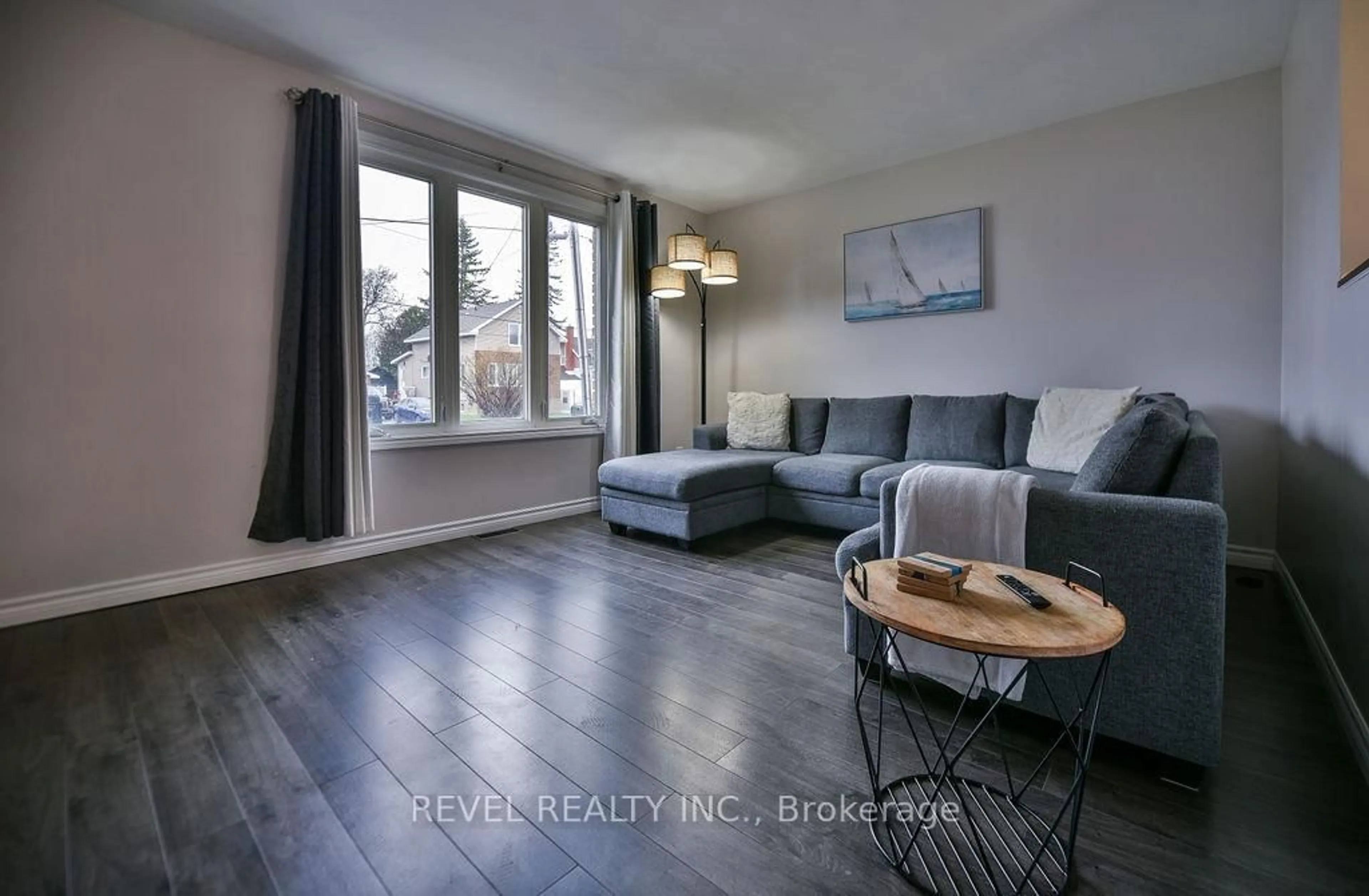 Living room with furniture, wood/laminate floor for 209 Sutherland St, Timmins Ontario P0N 1C0