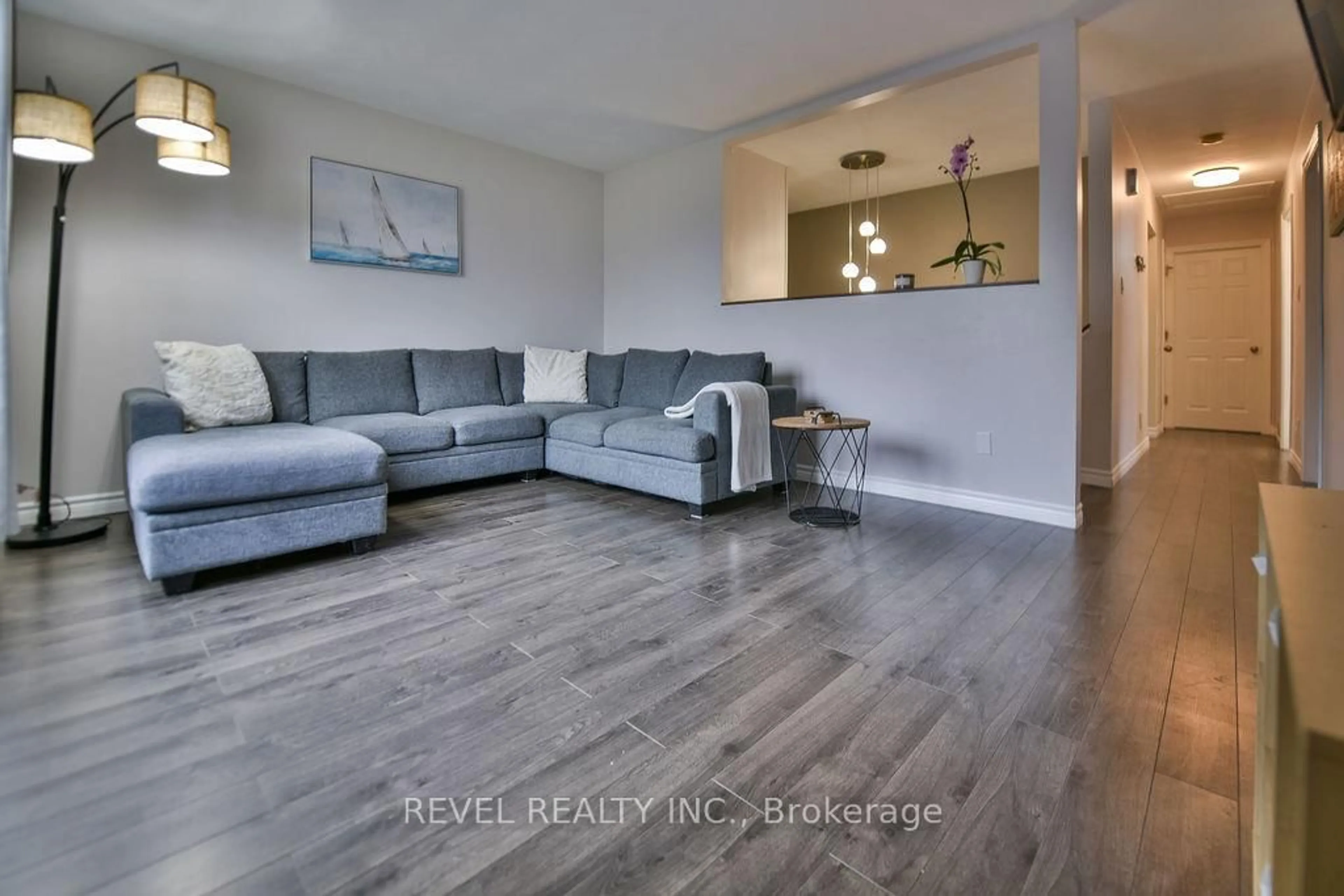 Living room with furniture, wood/laminate floor for 209 Sutherland St, Timmins Ontario P0N 1C0
