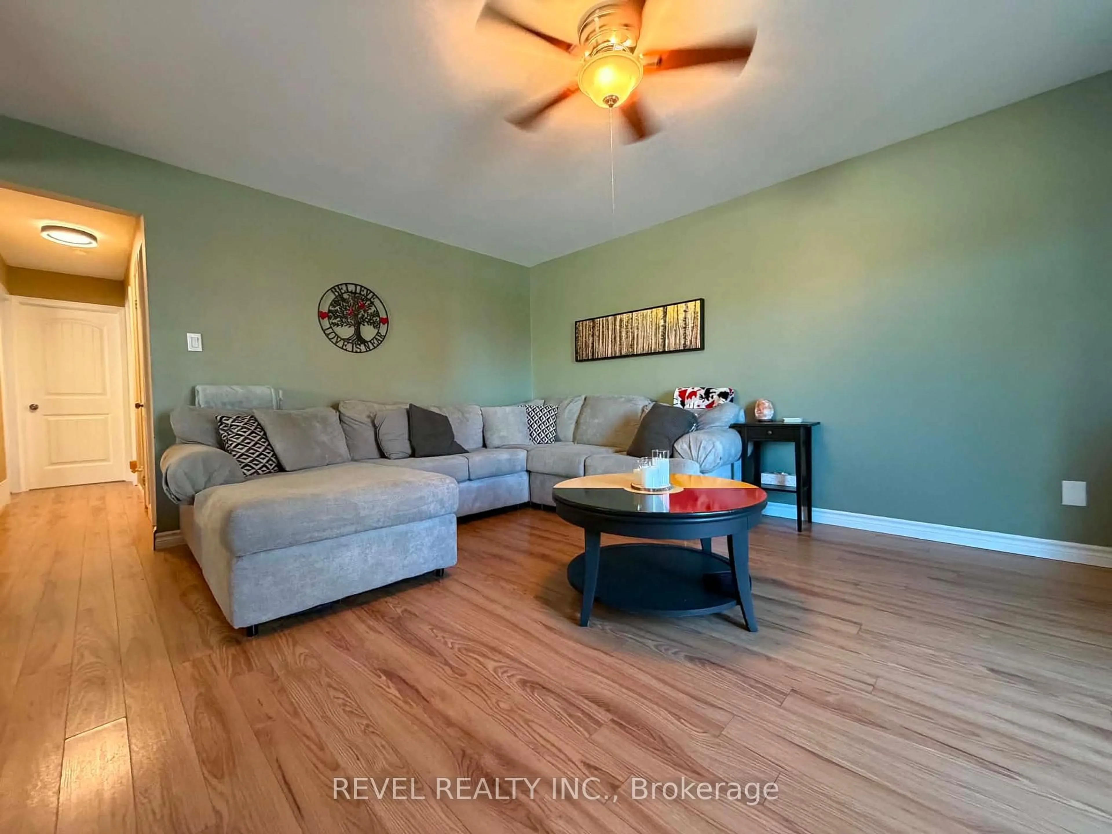 Living room with furniture, wood/laminate floor for 894 Suzanne St, Timmins Ontario P4P 1A9