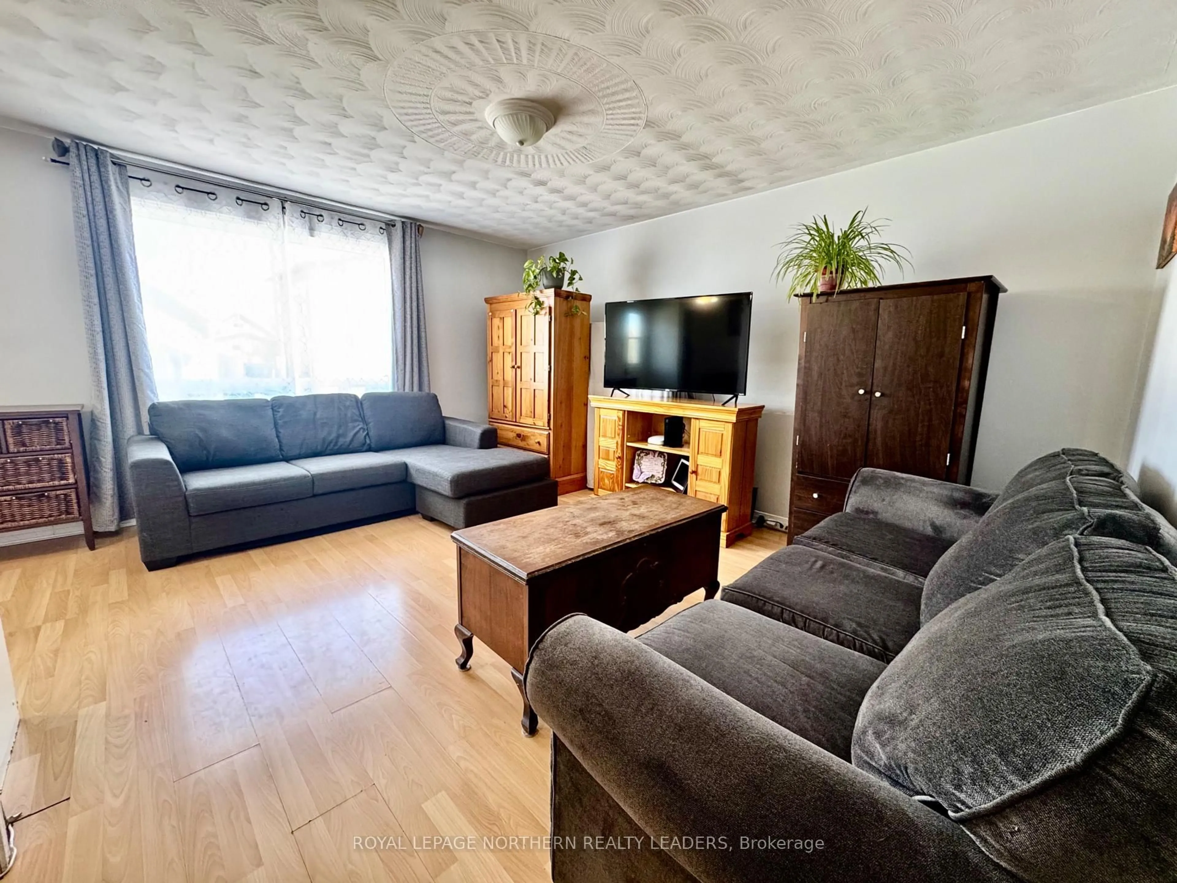 Living room with furniture, wood/laminate floor for 7 Borden Ave, Timmins Ontario P4N 4E6