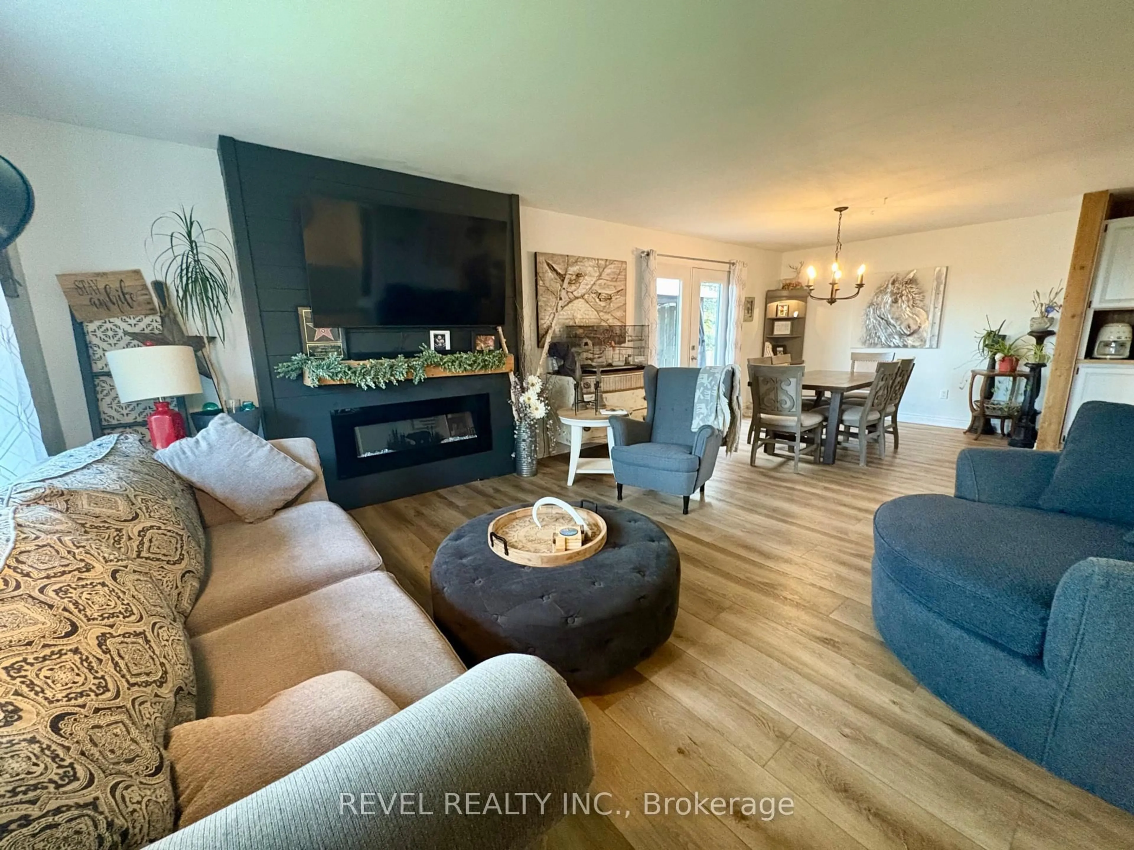 Living room with furniture, wood/laminate floor for 9 Cree Rd, Cochrane Ontario P0L 1C0