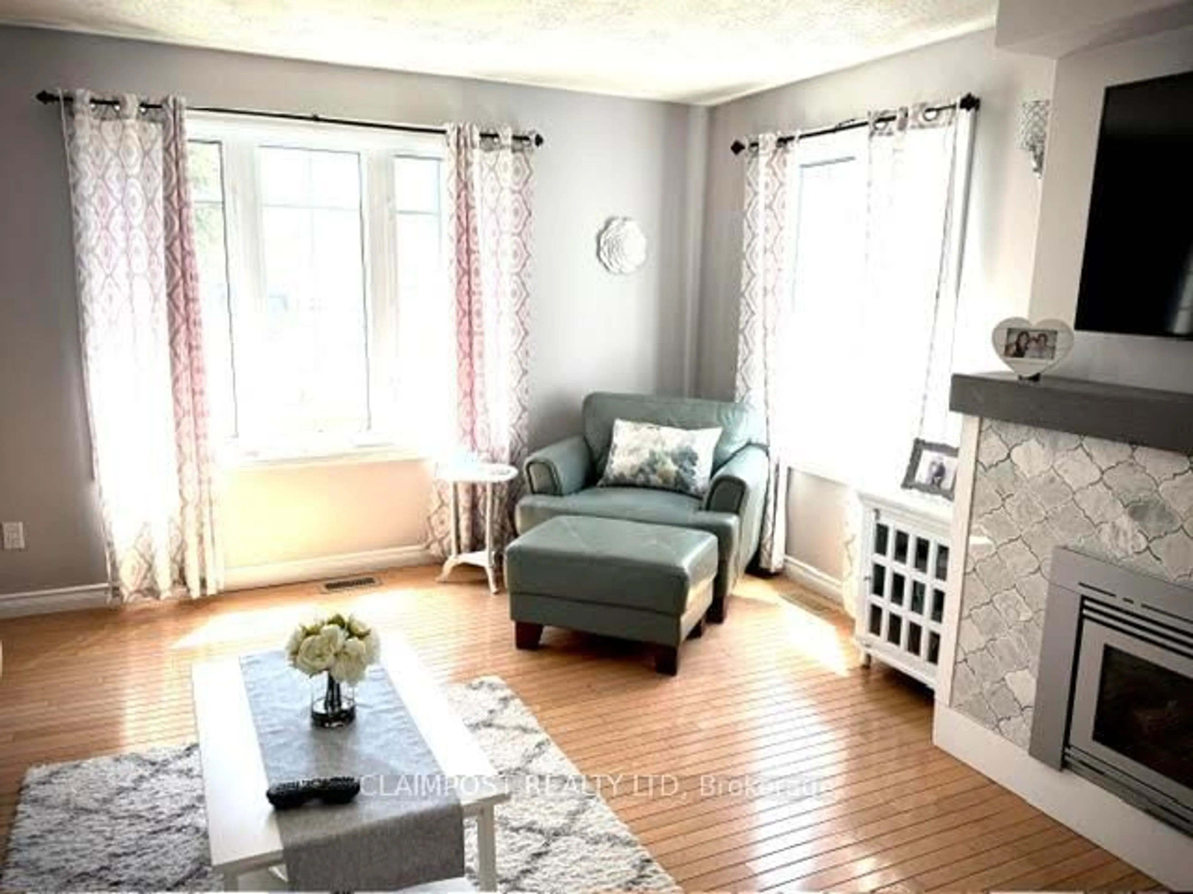 Living room with furniture, wood/laminate floor for 690 Howard Ave, Timmins Ontario P4N 5V8