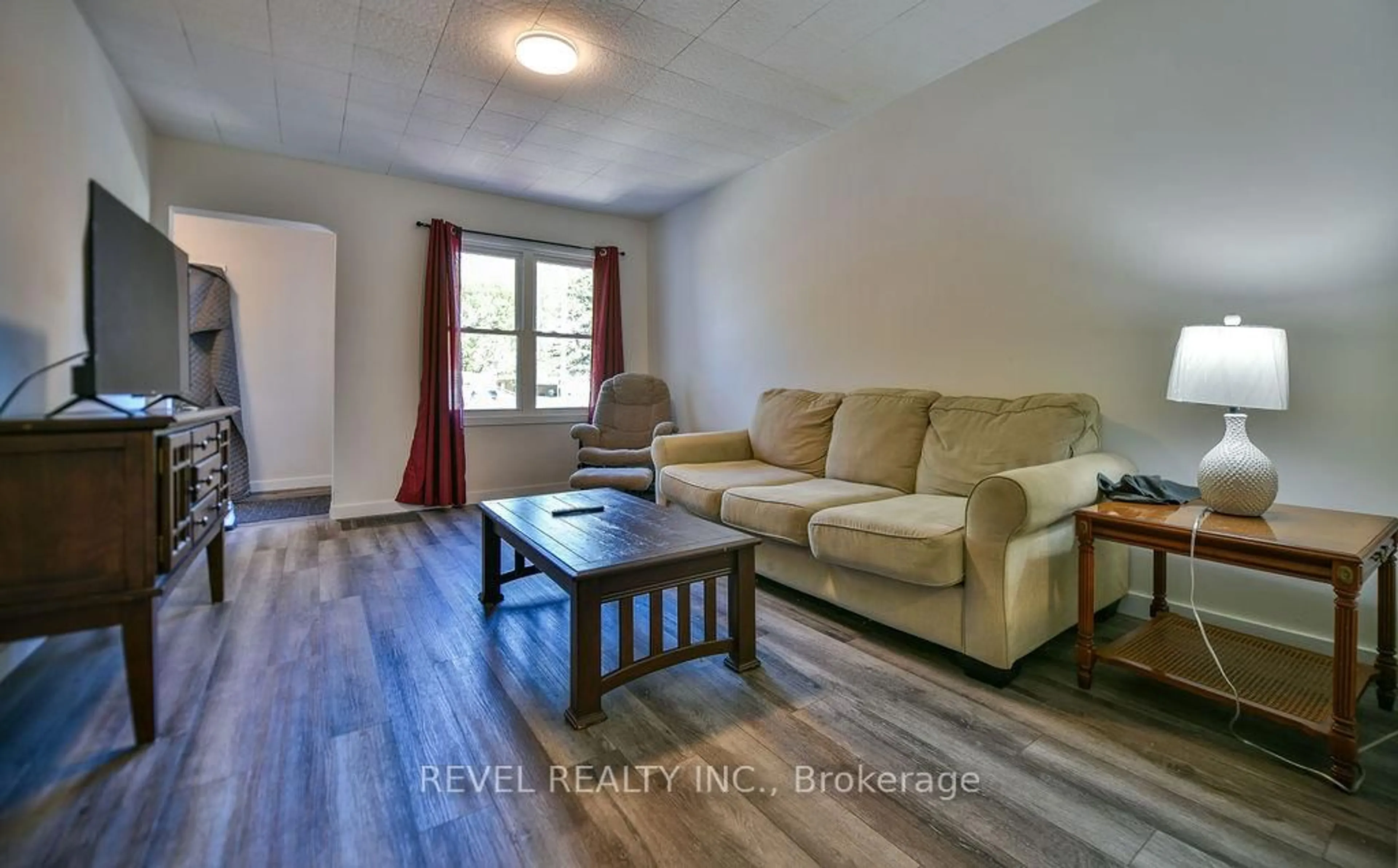 Living room with furniture, wood/laminate floor for 223 Cedar St, Timmins Ontario P4N 6J5