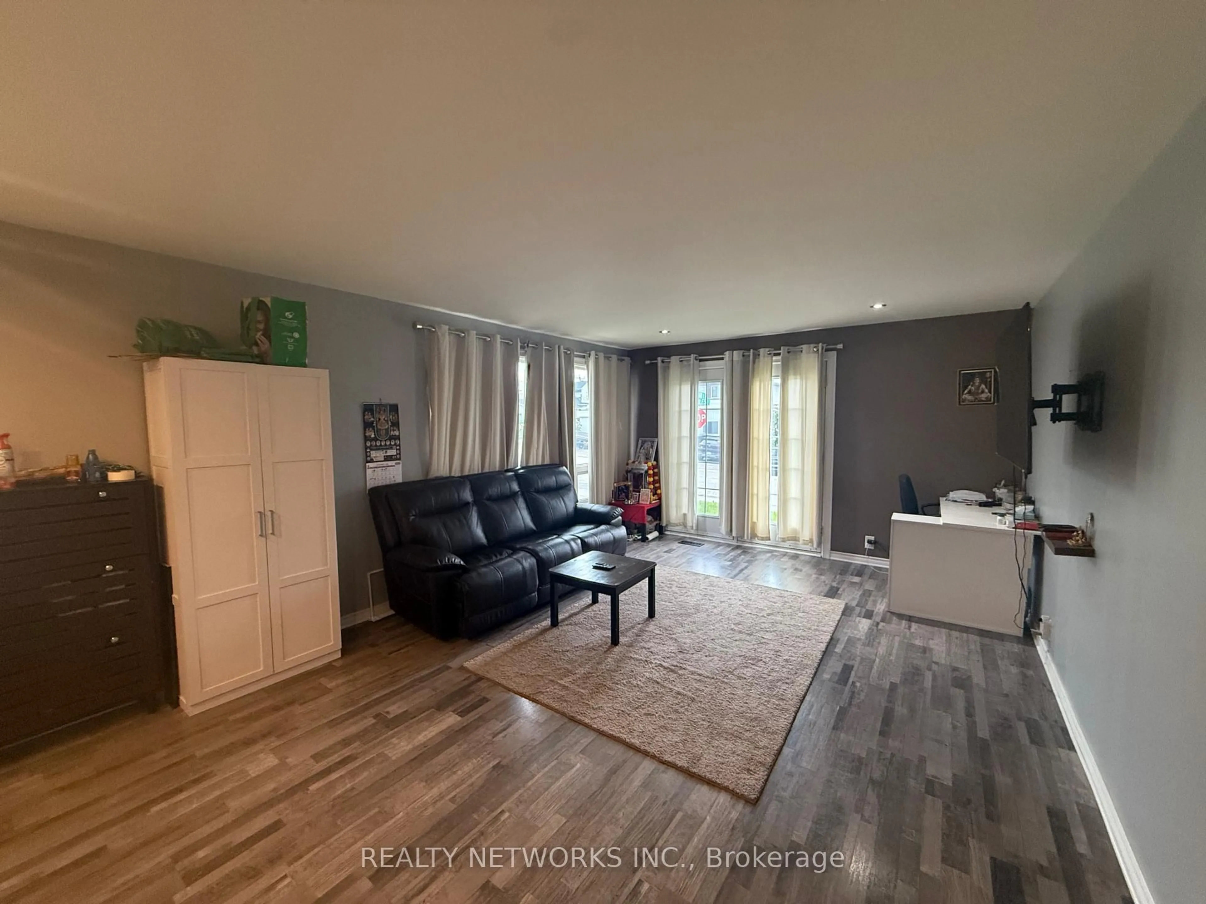 Living room with furniture, wood/laminate floor for 303 Poplar Ave, Timmins Ontario P4N 4S2