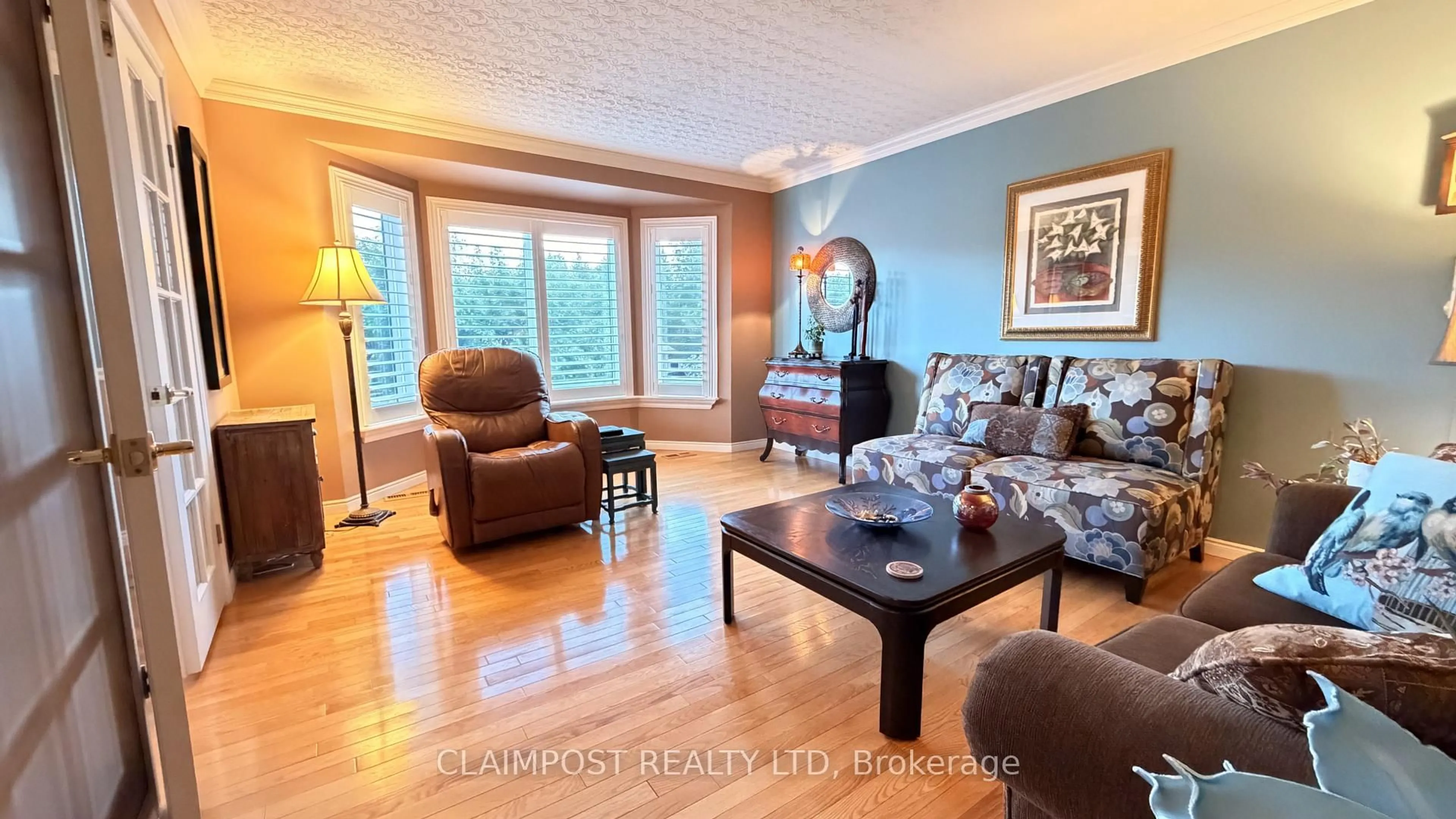 Living room with furniture, wood/laminate floor for 175 Claimpost Tr, Timmins Ontario P0N 1G0
