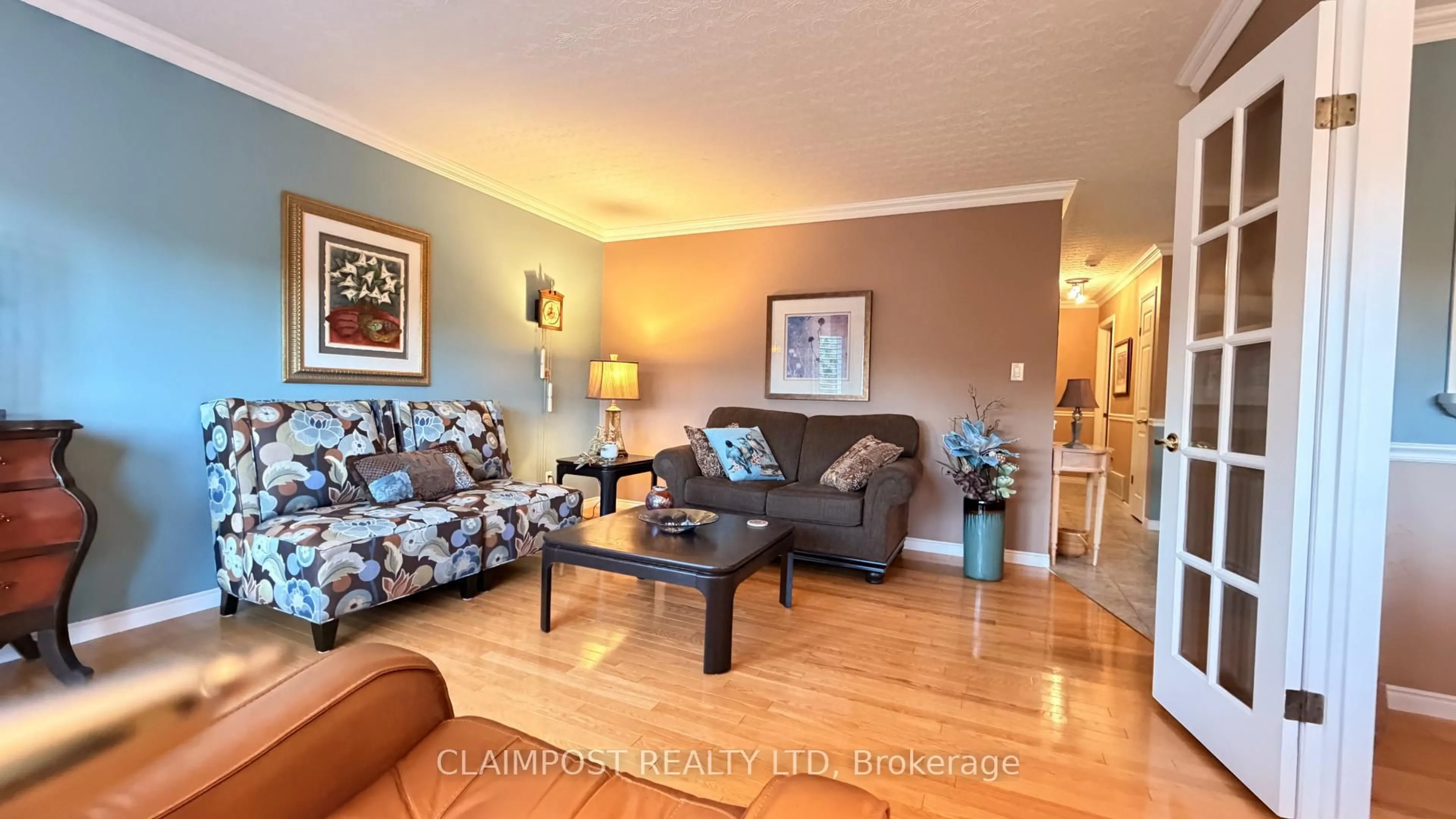 Living room with furniture, wood/laminate floor for 175 Claimpost Tr, Timmins Ontario P0N 1G0