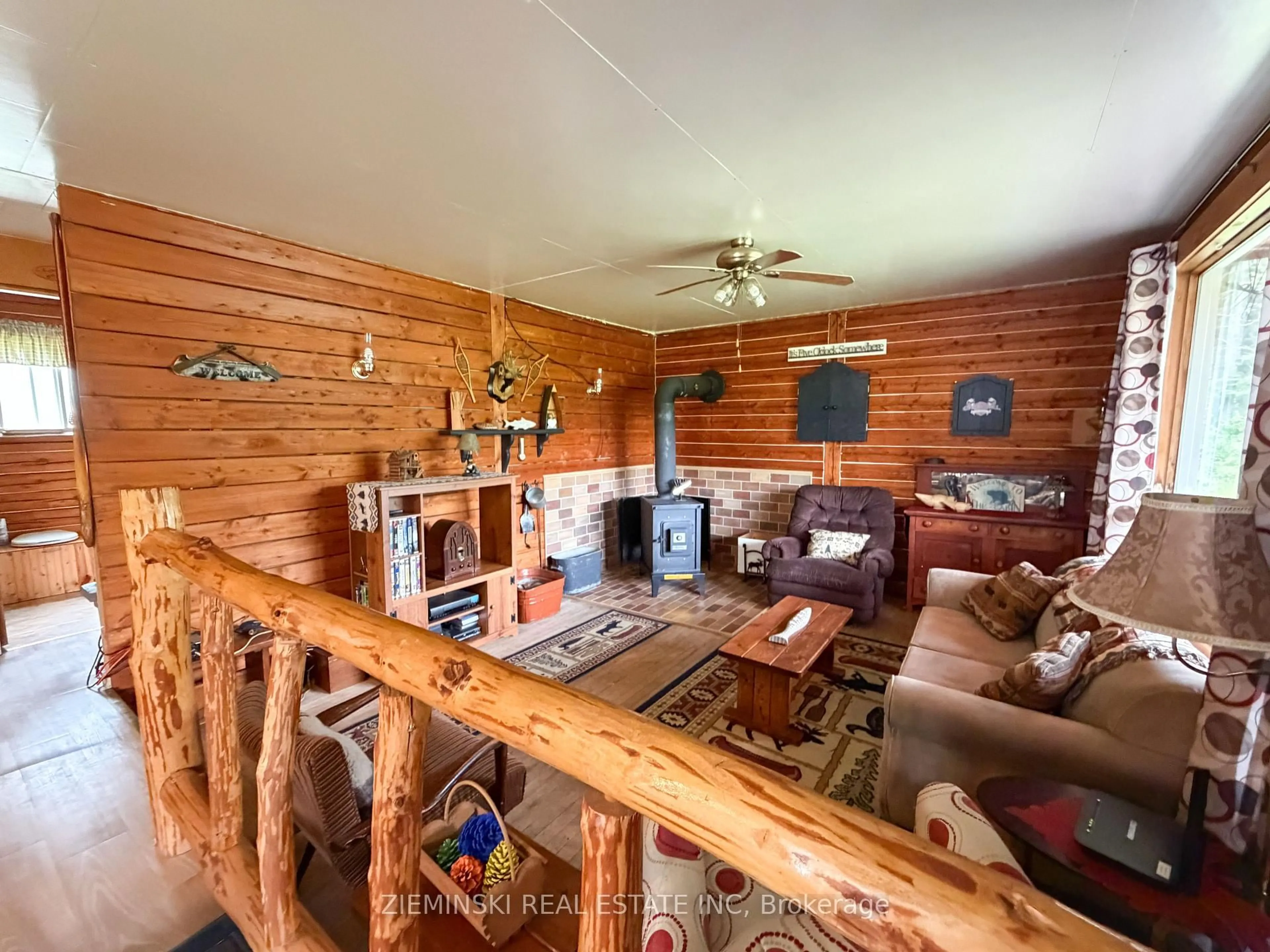 Living room with furniture, wood/laminate floor for 22 Rapids Ave, Cochrane Ontario P0L 1C0