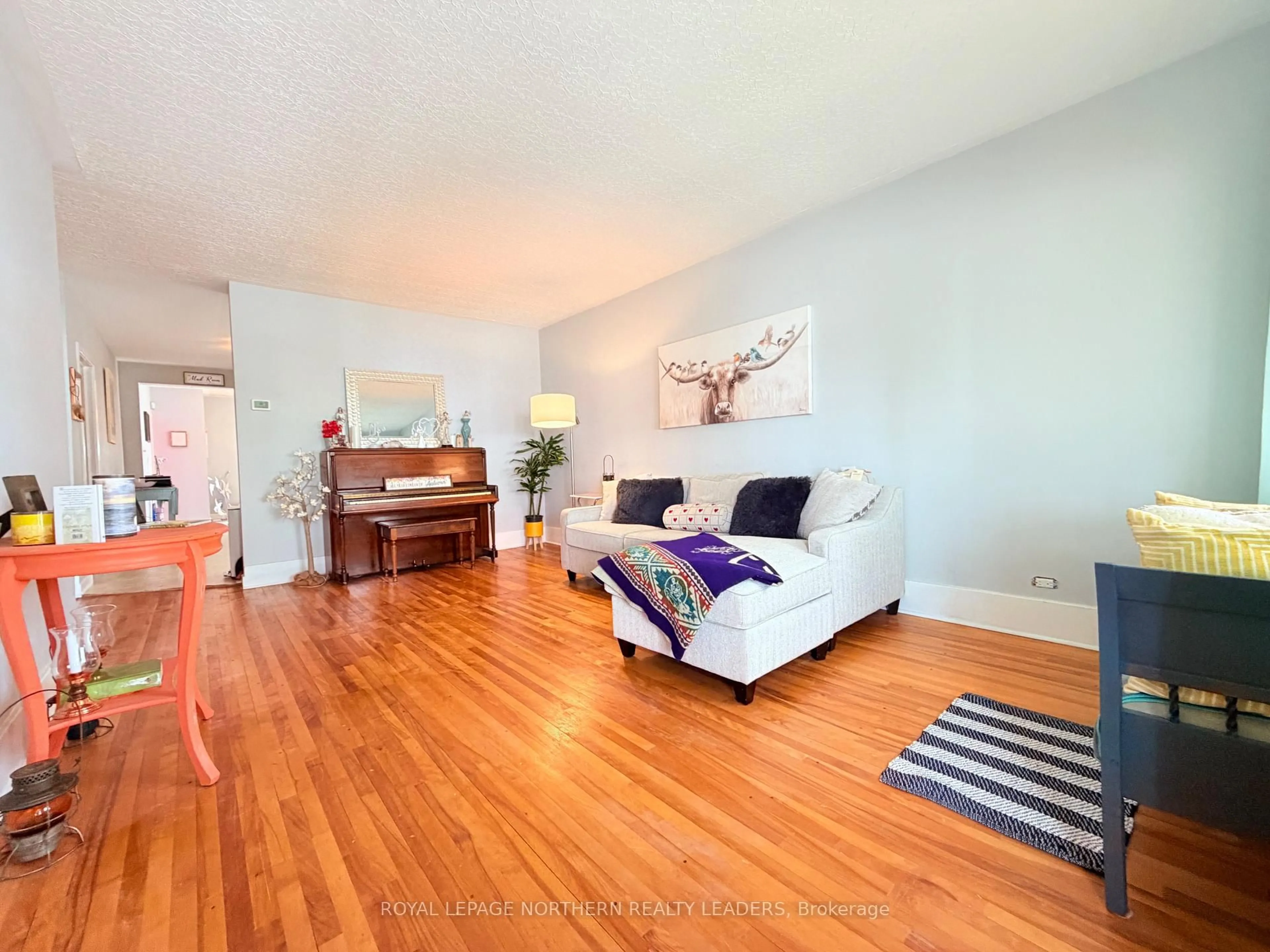Living room with furniture, wood/laminate floor for 348 Birch St, Timmins Ontario P4N 2B6
