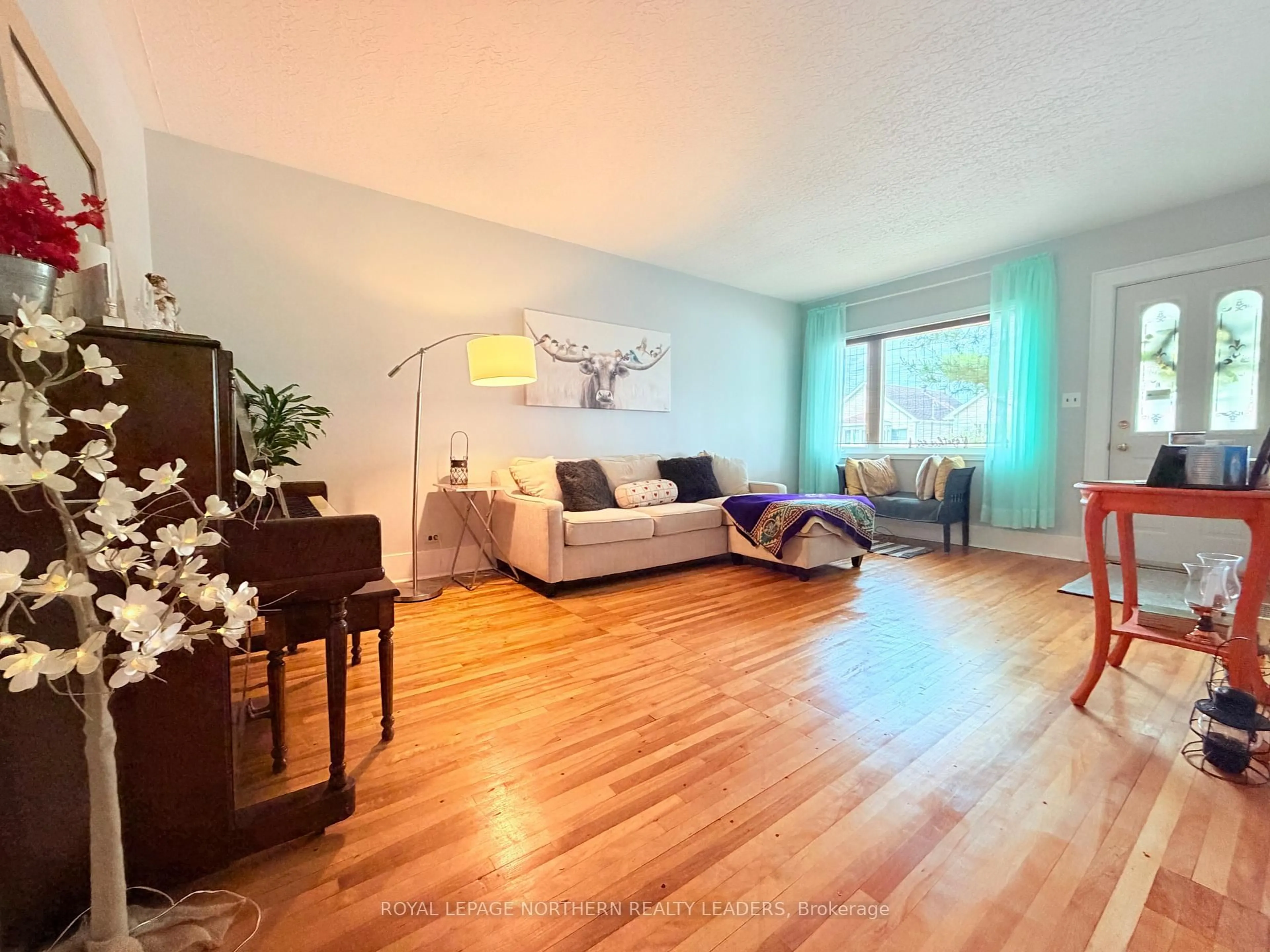 Living room with furniture, wood/laminate floor for 348 Birch St, Timmins Ontario P4N 2B6