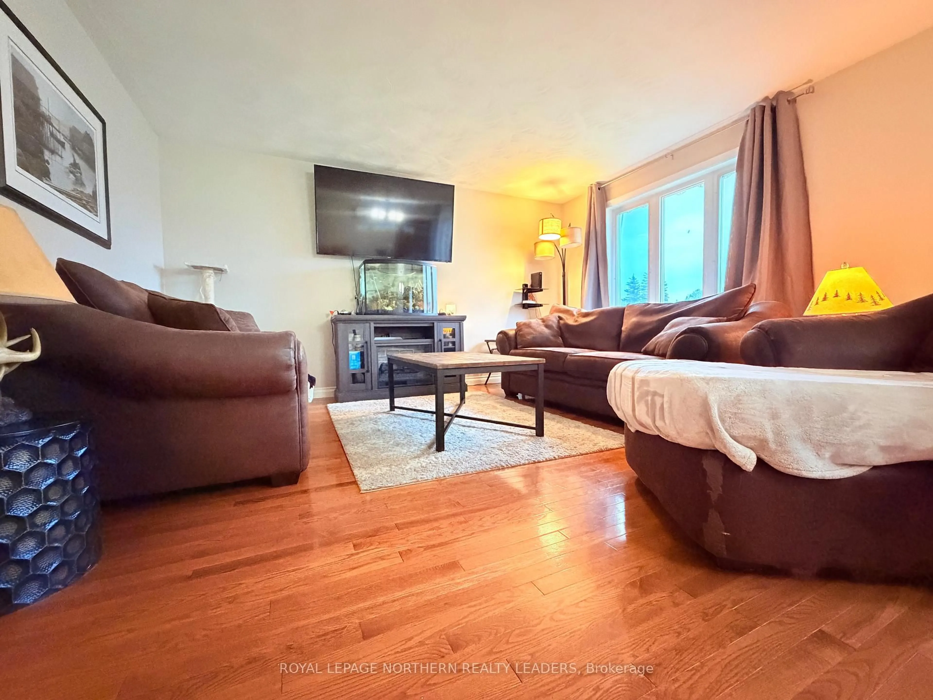 Living room with furniture, wood/laminate floor for 599 Lynwood Dr, Timmins Ontario P4N 8J7