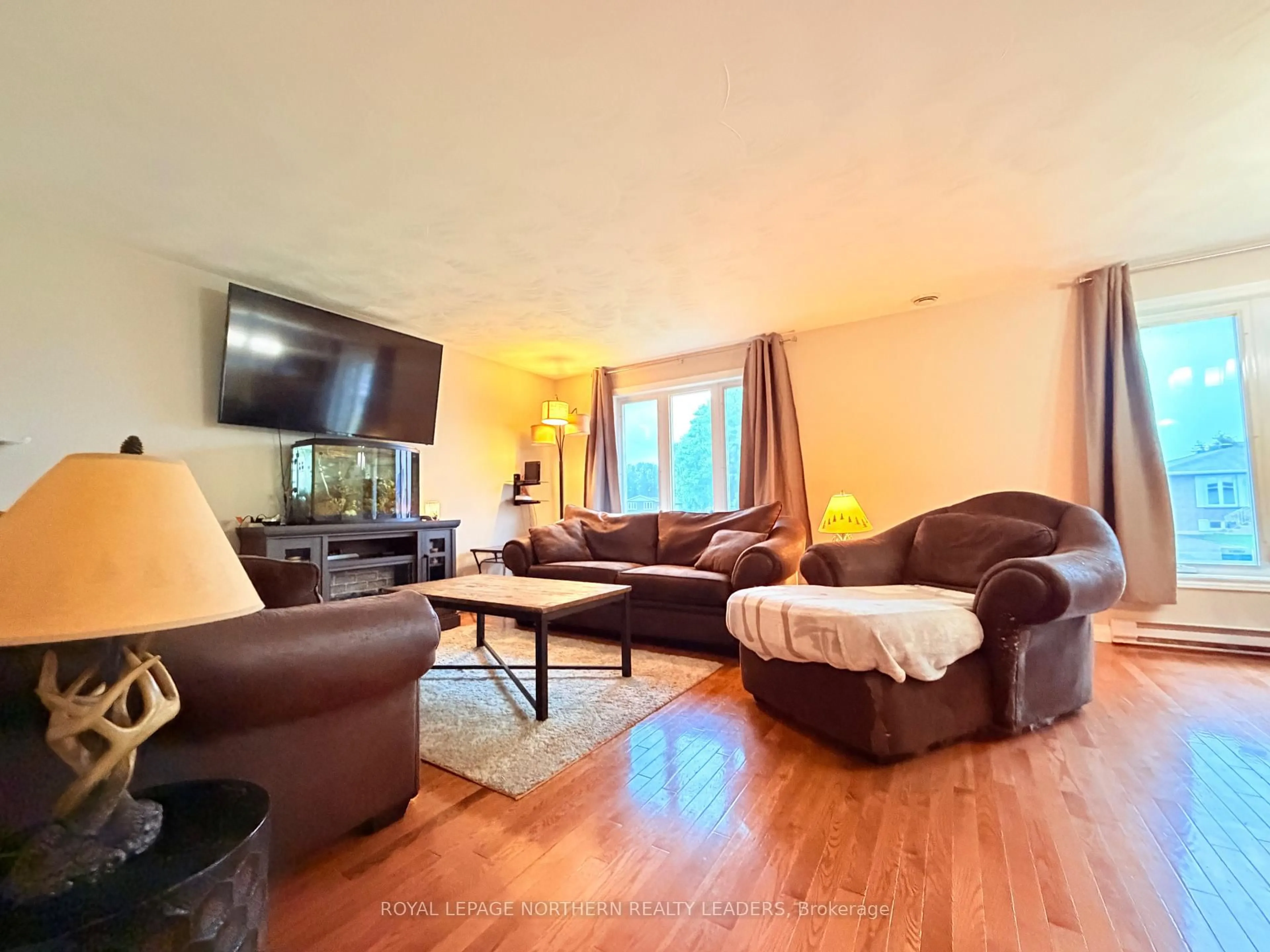 Living room with furniture, wood/laminate floor for 599 Lynwood Dr, Timmins Ontario P4N 8J7
