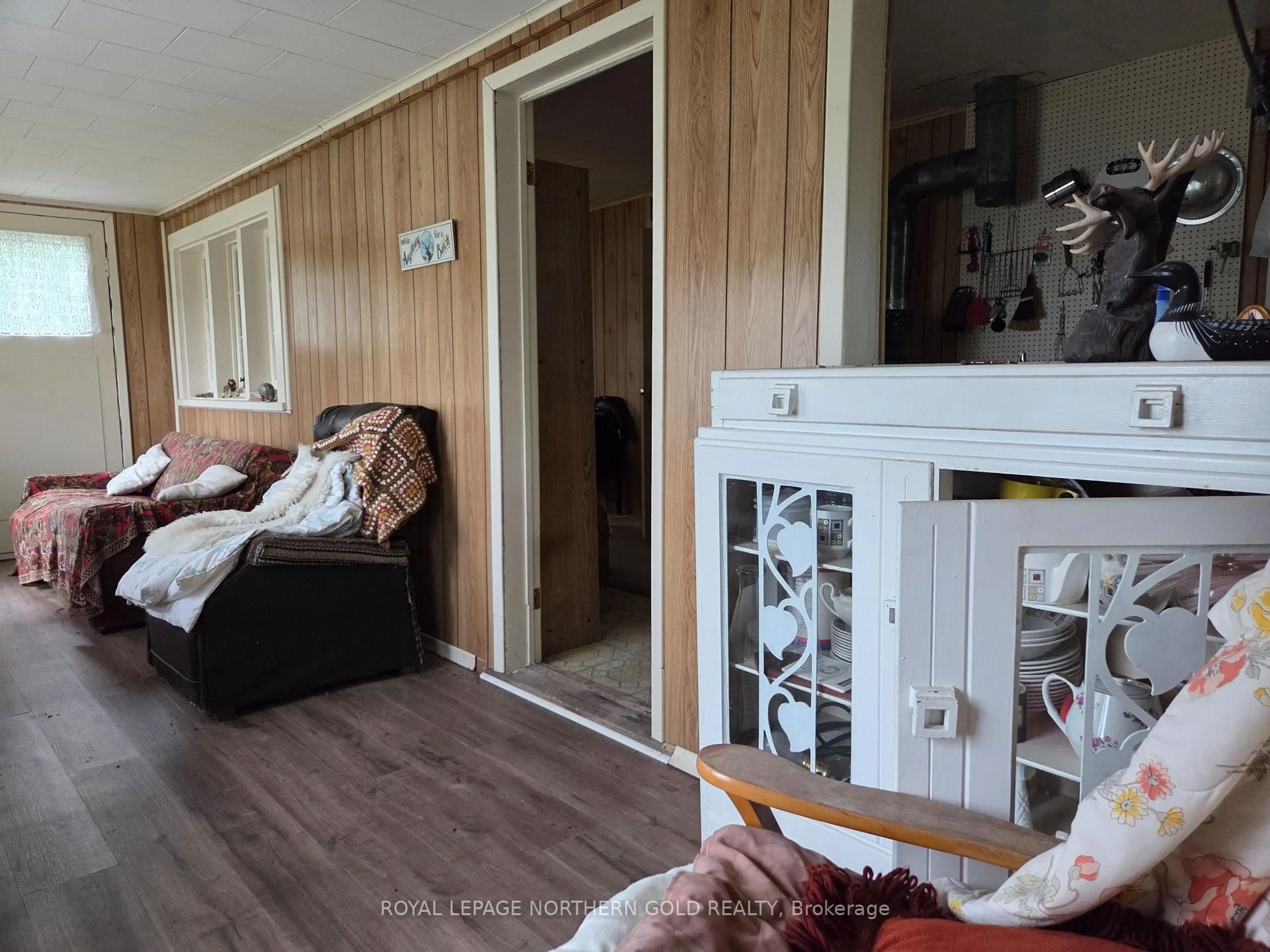 Living room with furniture, wood/laminate floor for 425 Bouchard Rd, Kirkland Lake Ontario P0K 1N0