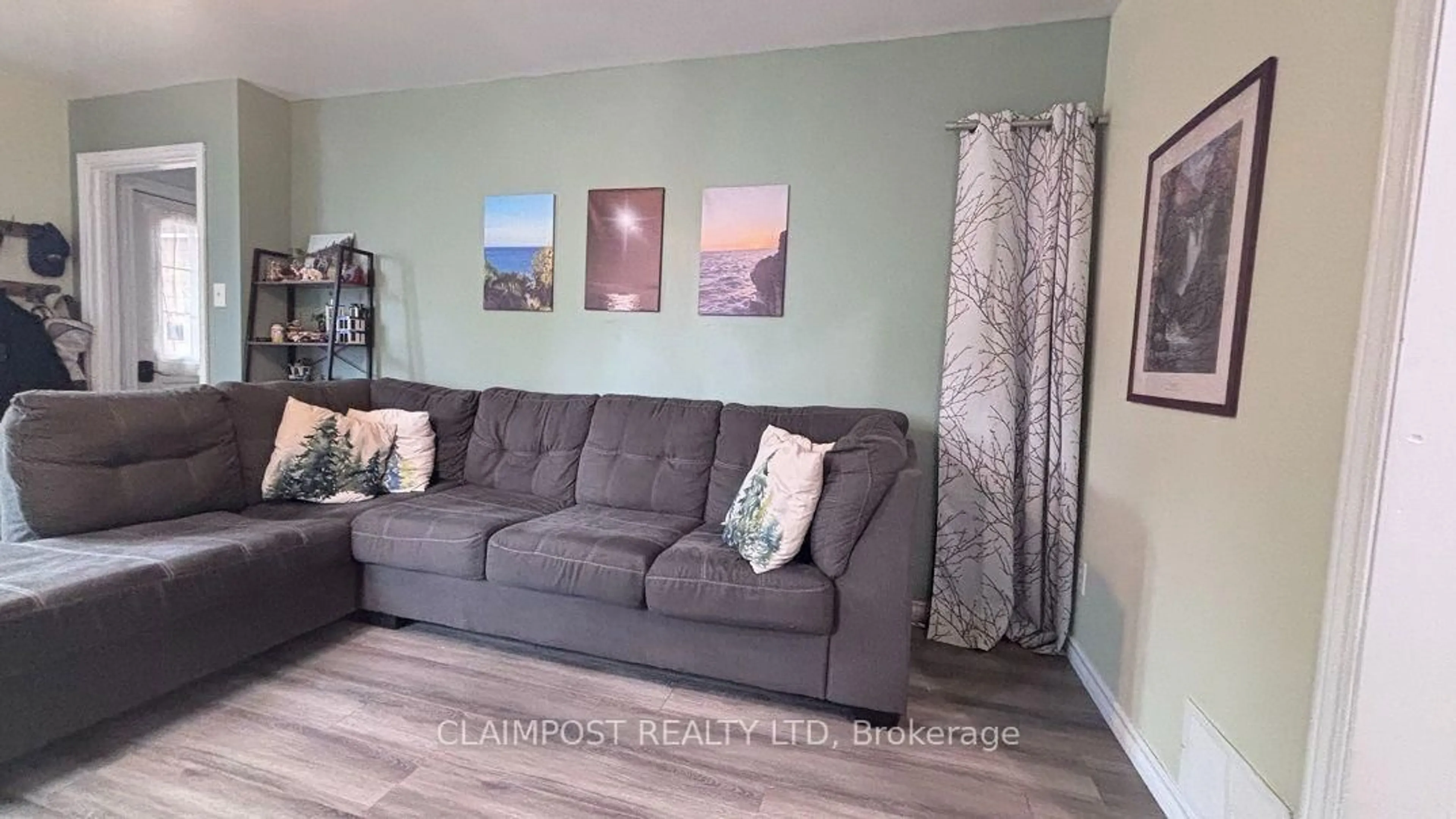 Living room with furniture, wood/laminate floor for 281 Cherry St, Timmins Ontario P4N 6W5
