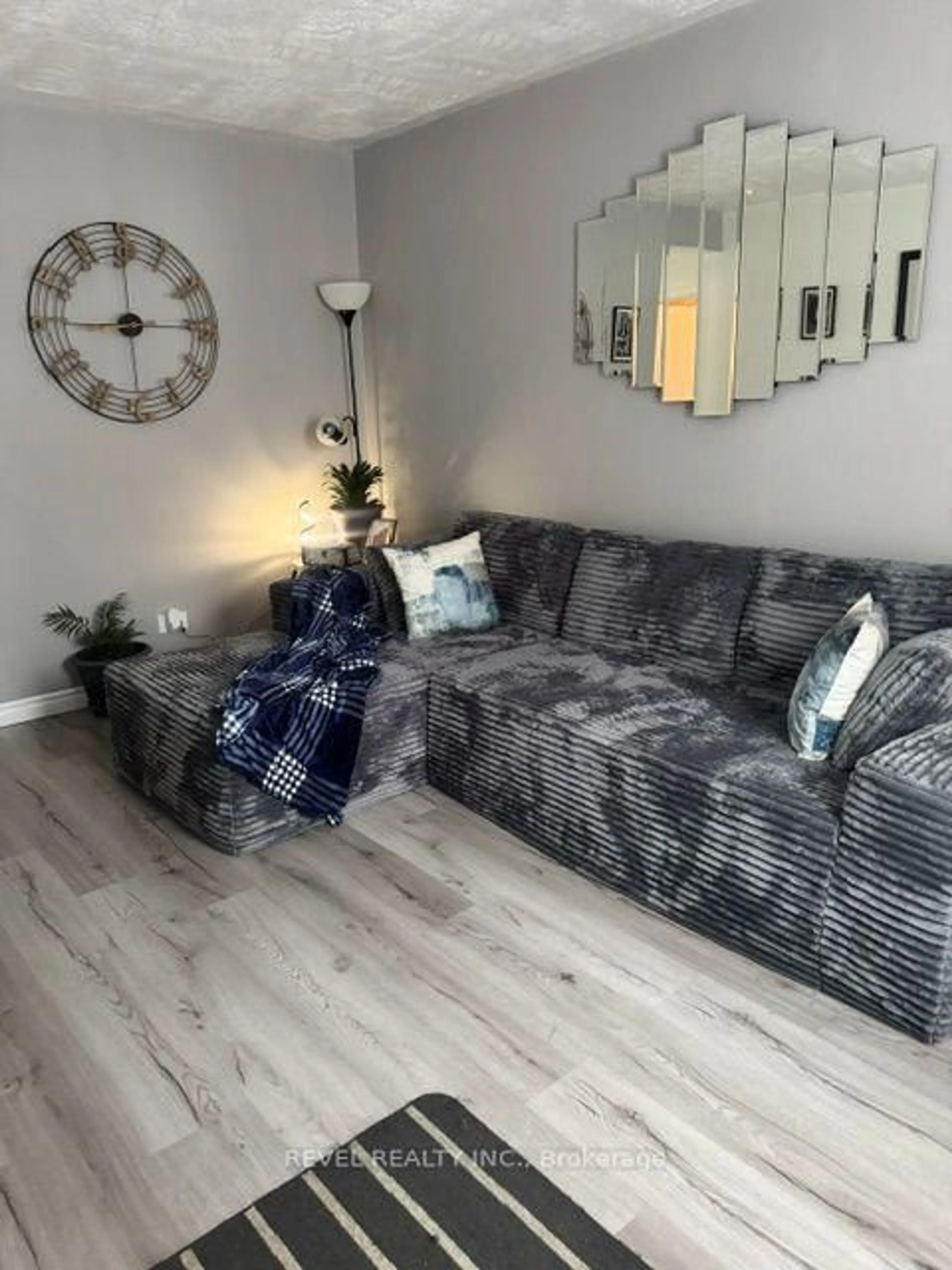 Living room with furniture, wood/laminate floor for 393 Pine St, Timmins Ontario P4N 6L6
