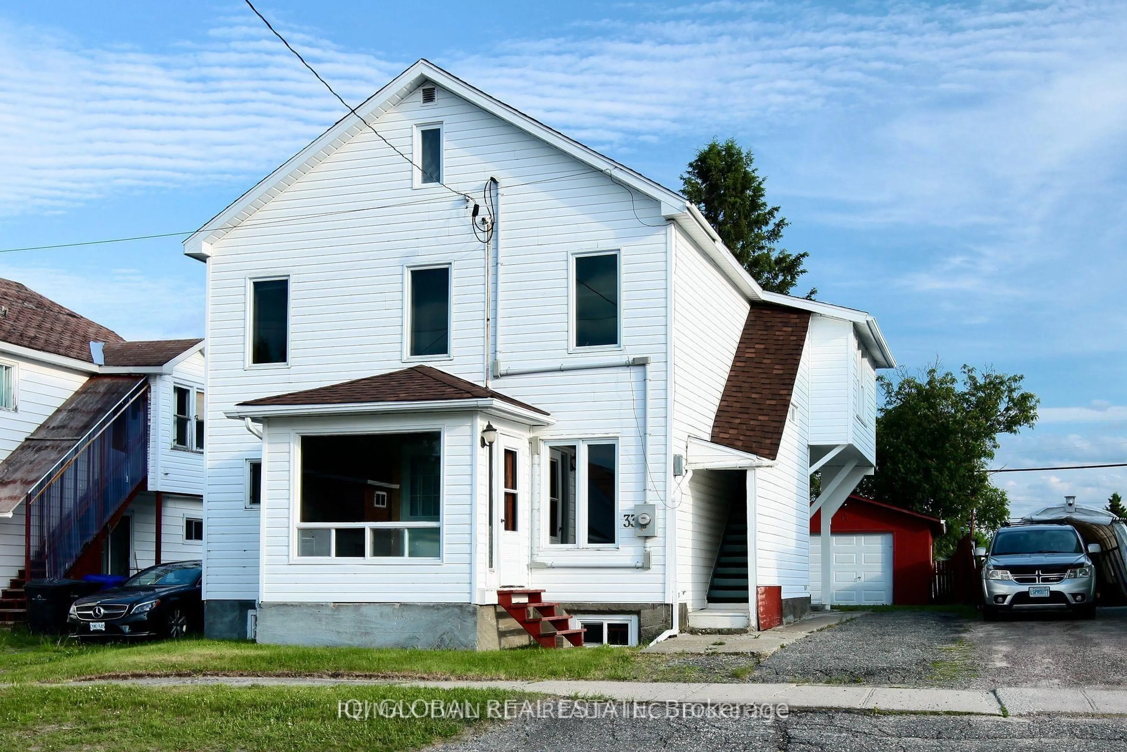 Home with vinyl exterior material, street for 33 McKelvie Ave, Kirkland Lake Ontario P2N 2K3