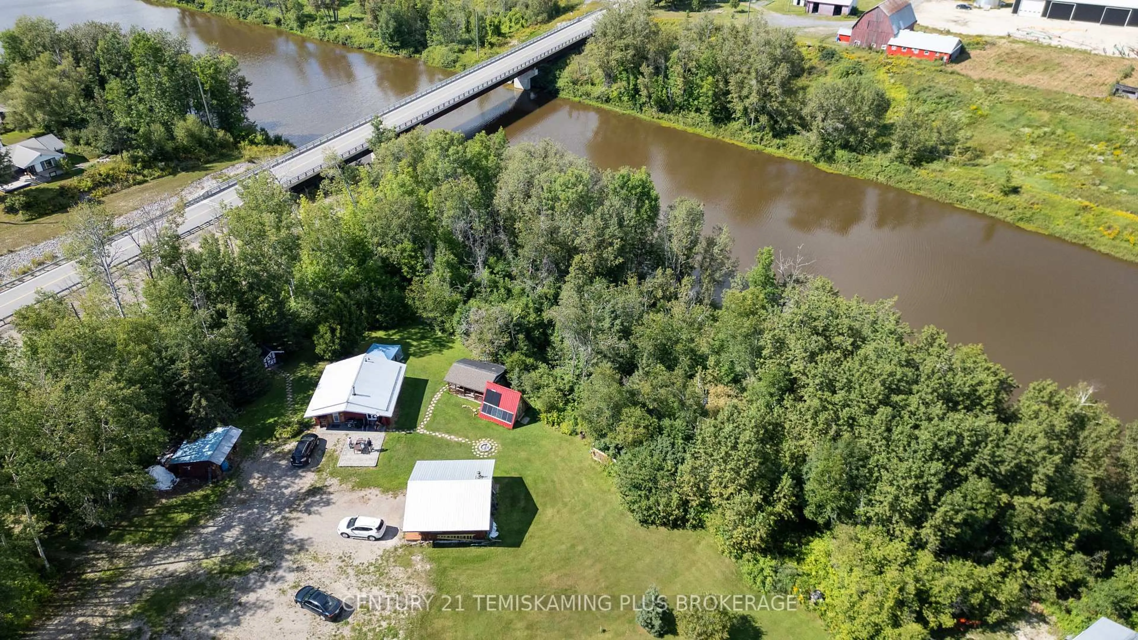A pic from outside/outdoor area/front of a property/back of a property/a pic from drone, water/lake/river/ocean view for 951701 Highway 569, Timiskaming Ontario P0J 1L0