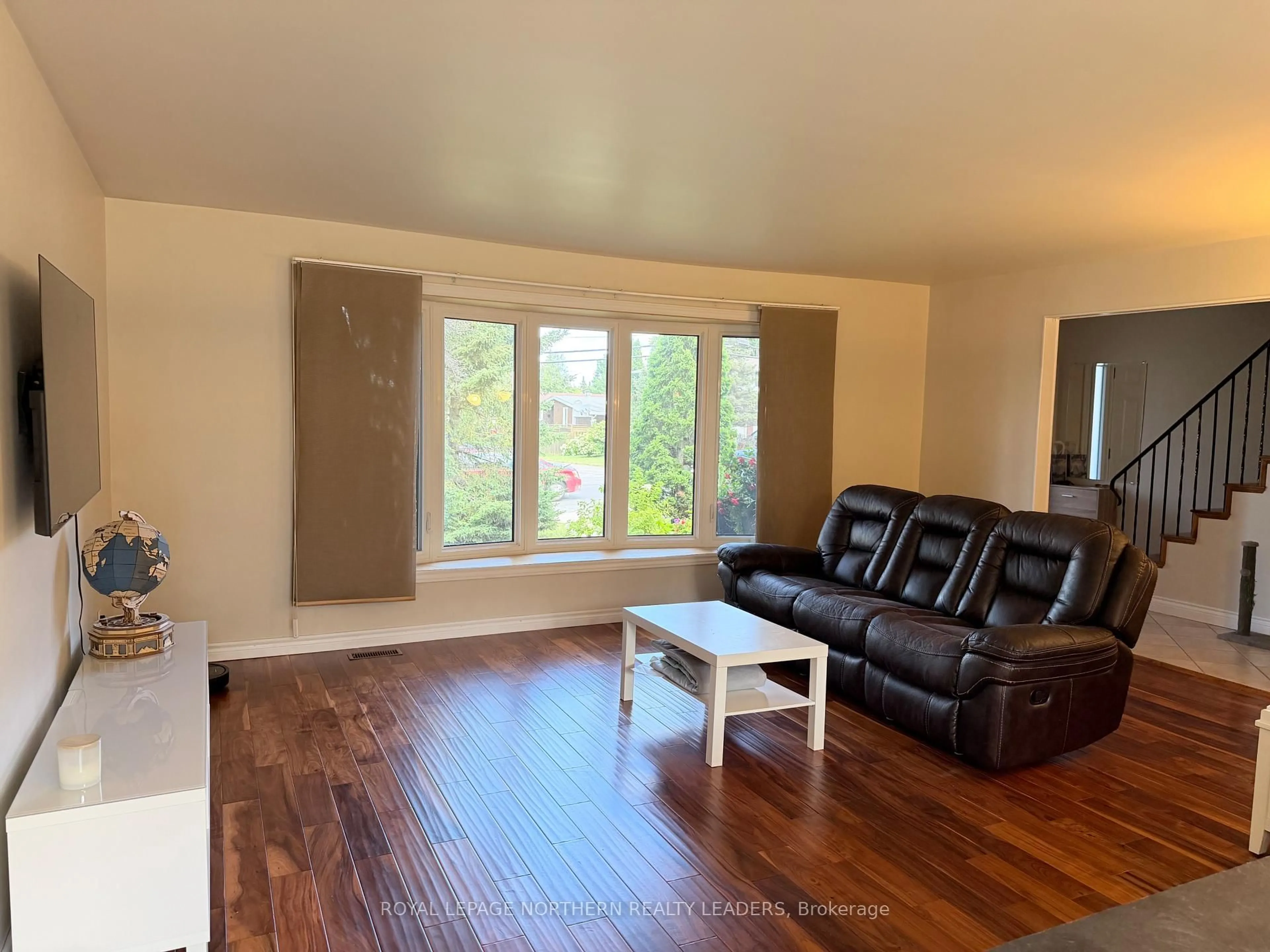 Living room with furniture, wood/laminate floor for 441 Ross Ave, Timmins Ontario P4N 5X5