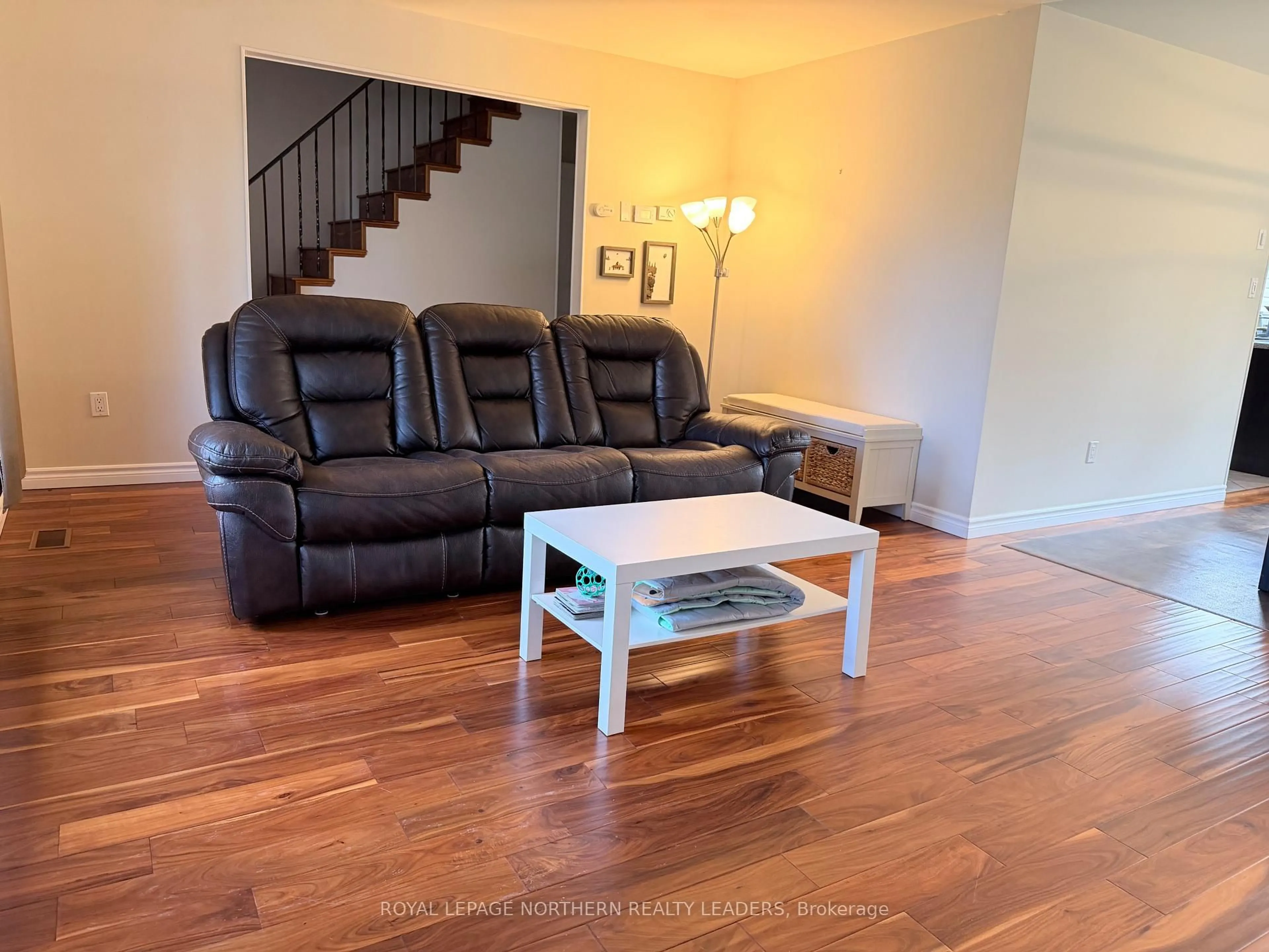 Living room with furniture, wood/laminate floor for 441 Ross Ave, Timmins Ontario P4N 5X5