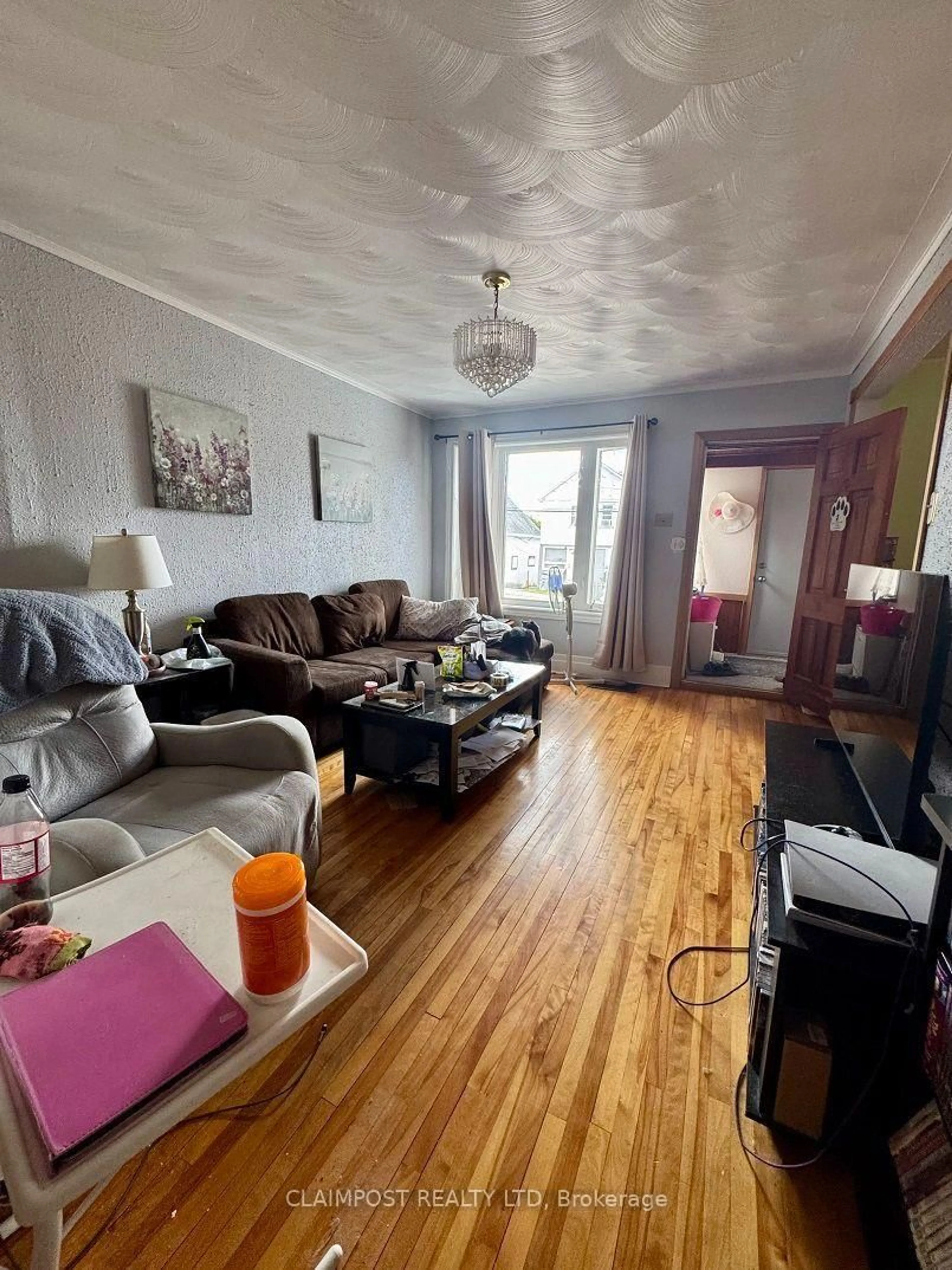 Living room with furniture, wood/laminate floor for 164 Pine St, Timmins Ontario P4N 6L1