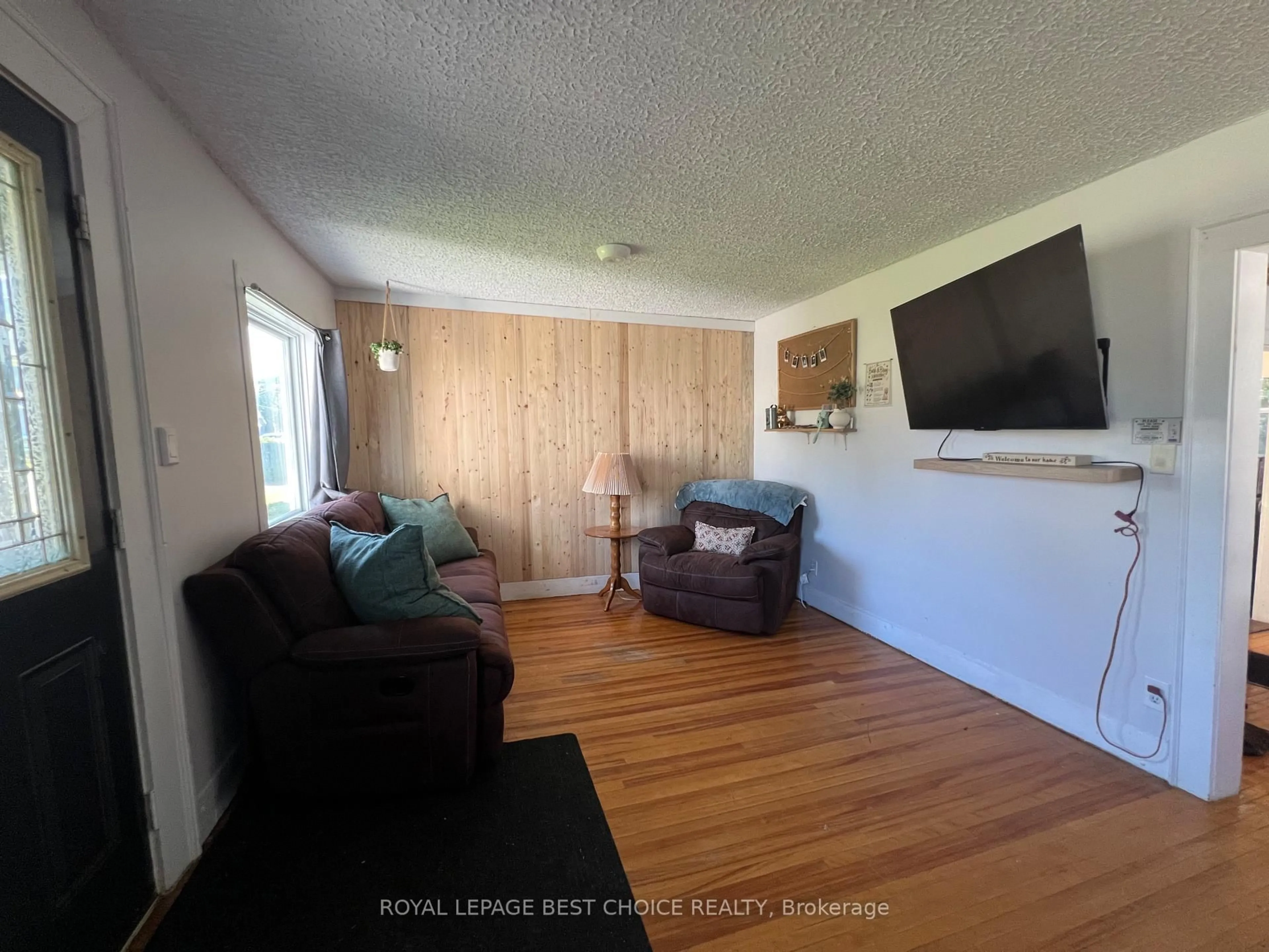 Living room with furniture, wood/laminate floor for 246 McCamus Ave, Temiskaming Shores Ontario P0J 1P0