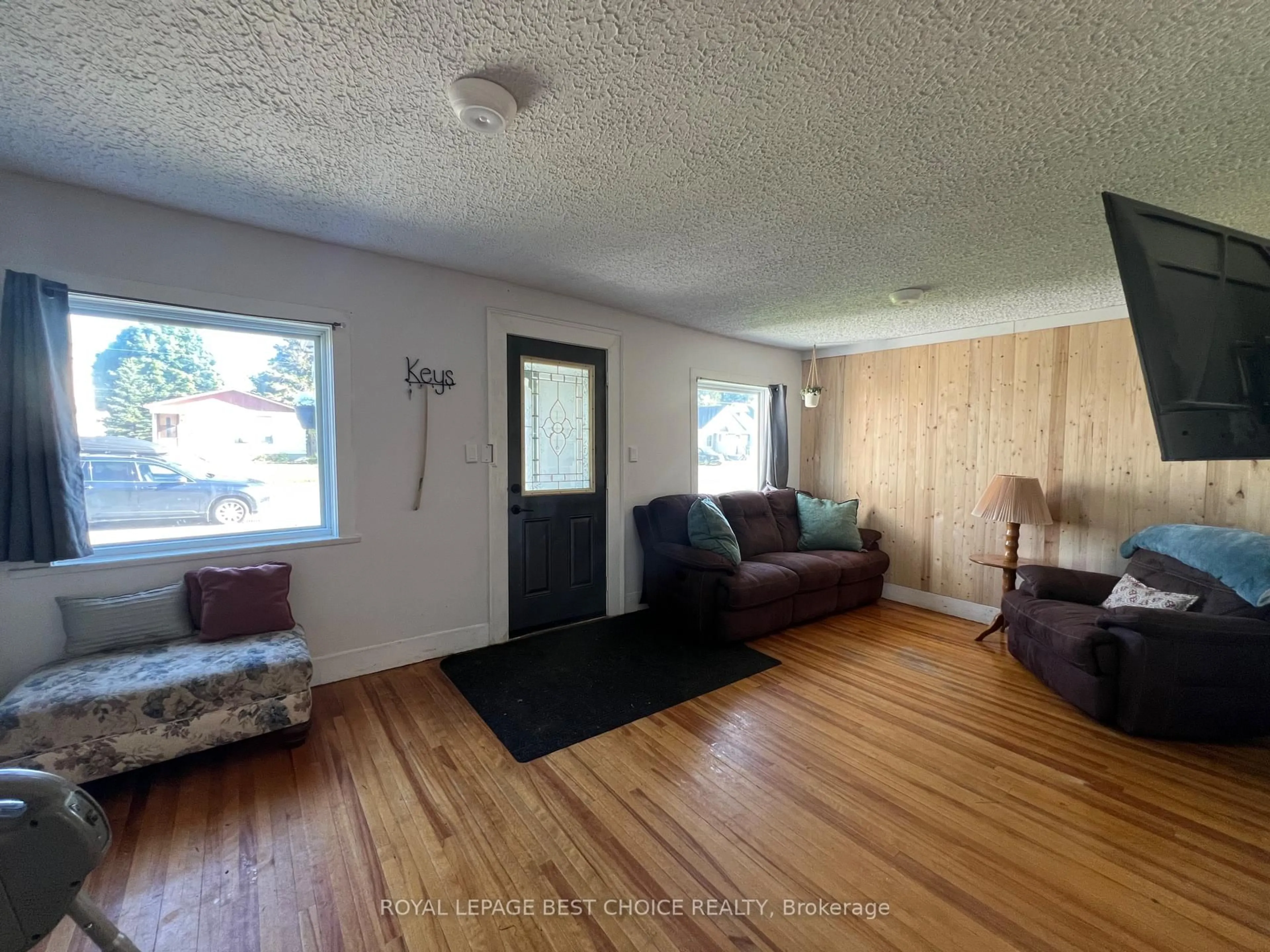 Living room with furniture, wood/laminate floor for 246 McCamus Ave, Temiskaming Shores Ontario P0J 1P0