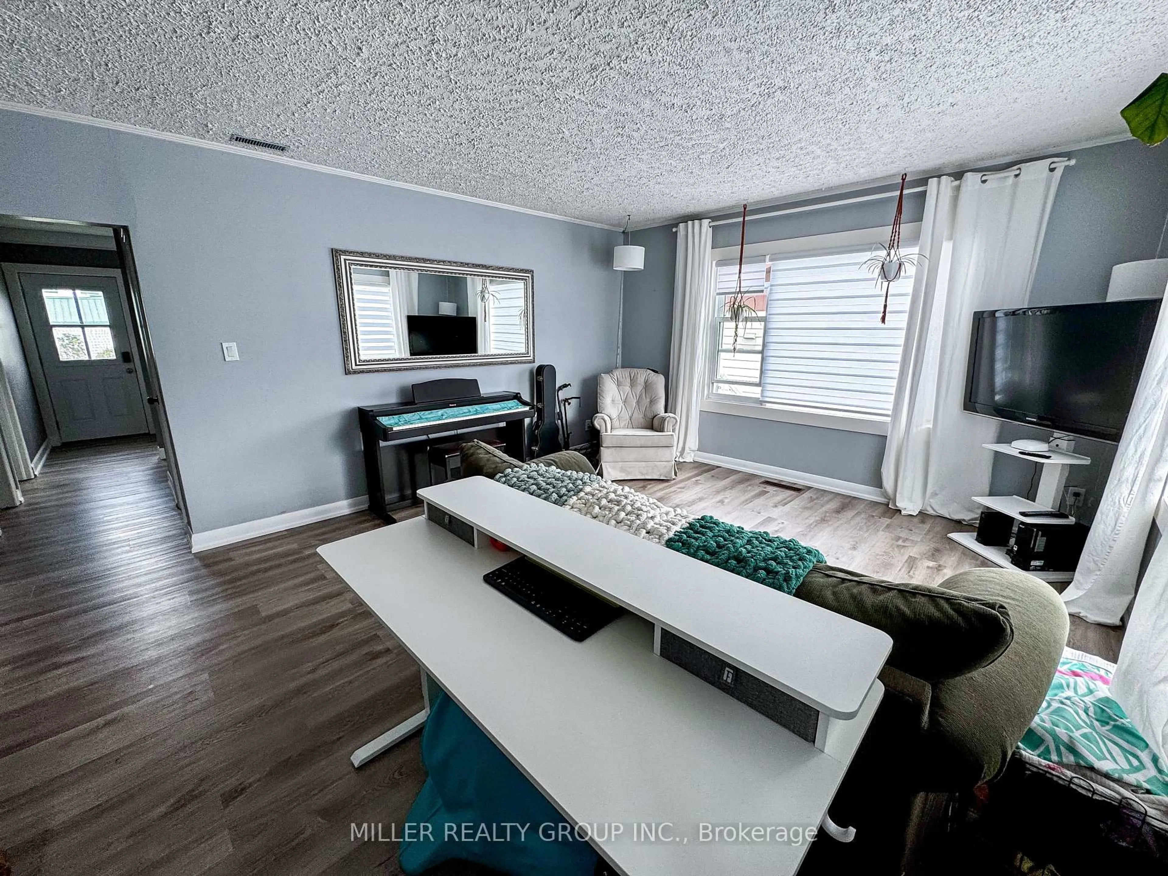 Living room with furniture, wood/laminate floor for 347 View St, Temiskaming Shores Ontario P0J 1K0