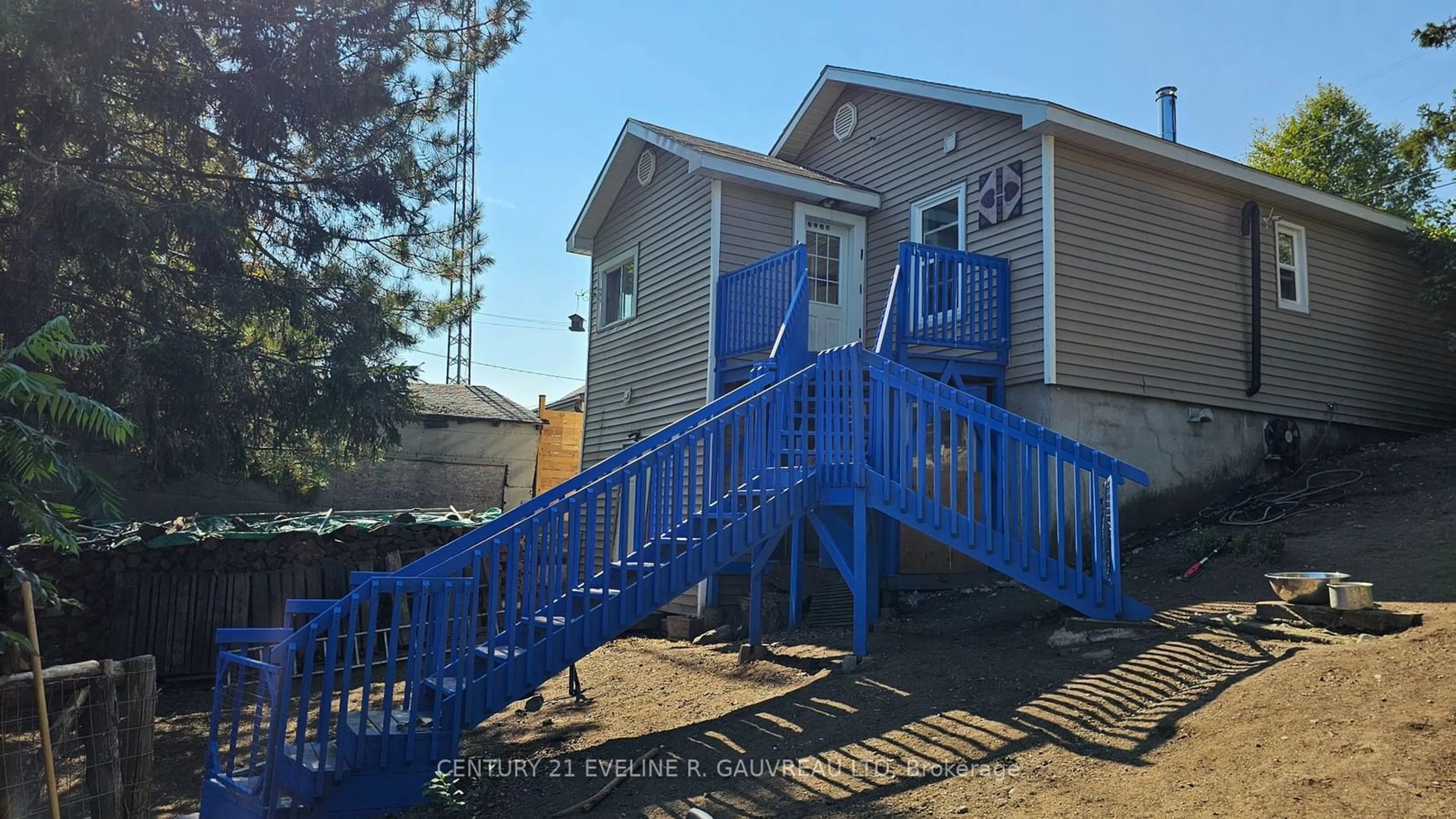 A pic from exterior of the house or condo, the fenced backyard for 63 Silver St, Cobalt Ontario P0J 1C0