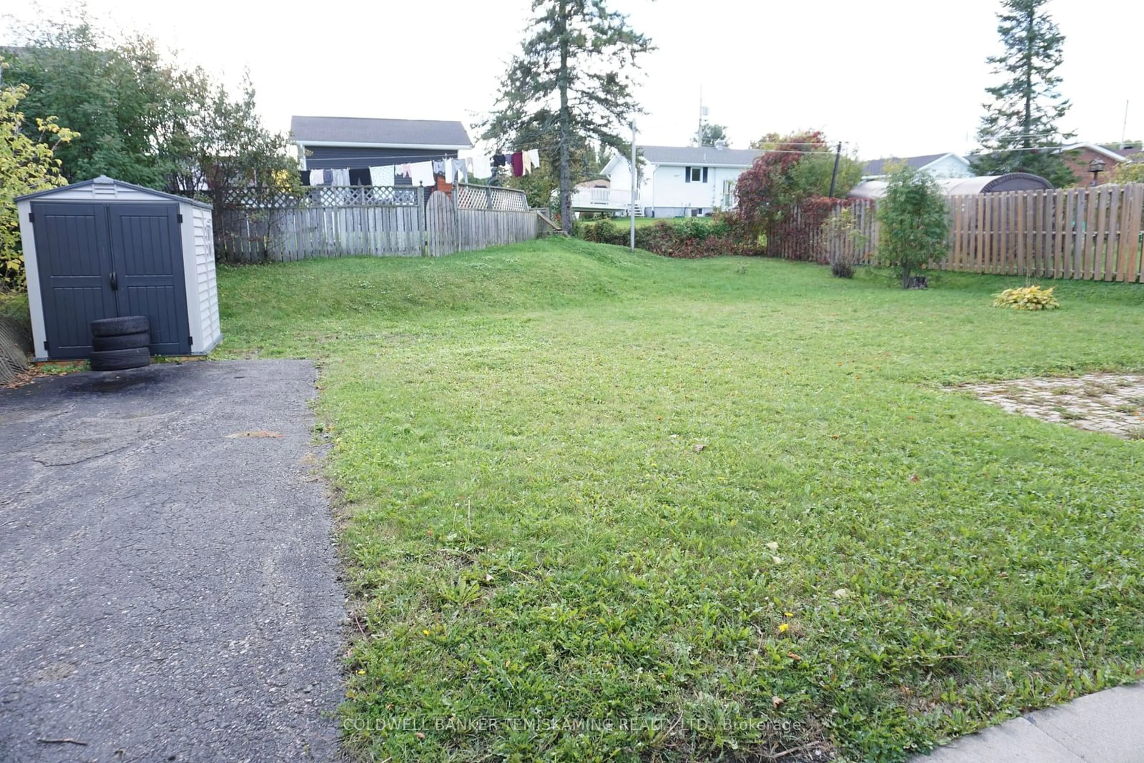 Frontside or backside of a home, the fenced backyard for 416 CECIL St, Temiskaming Shores Ontario P0J 1K0