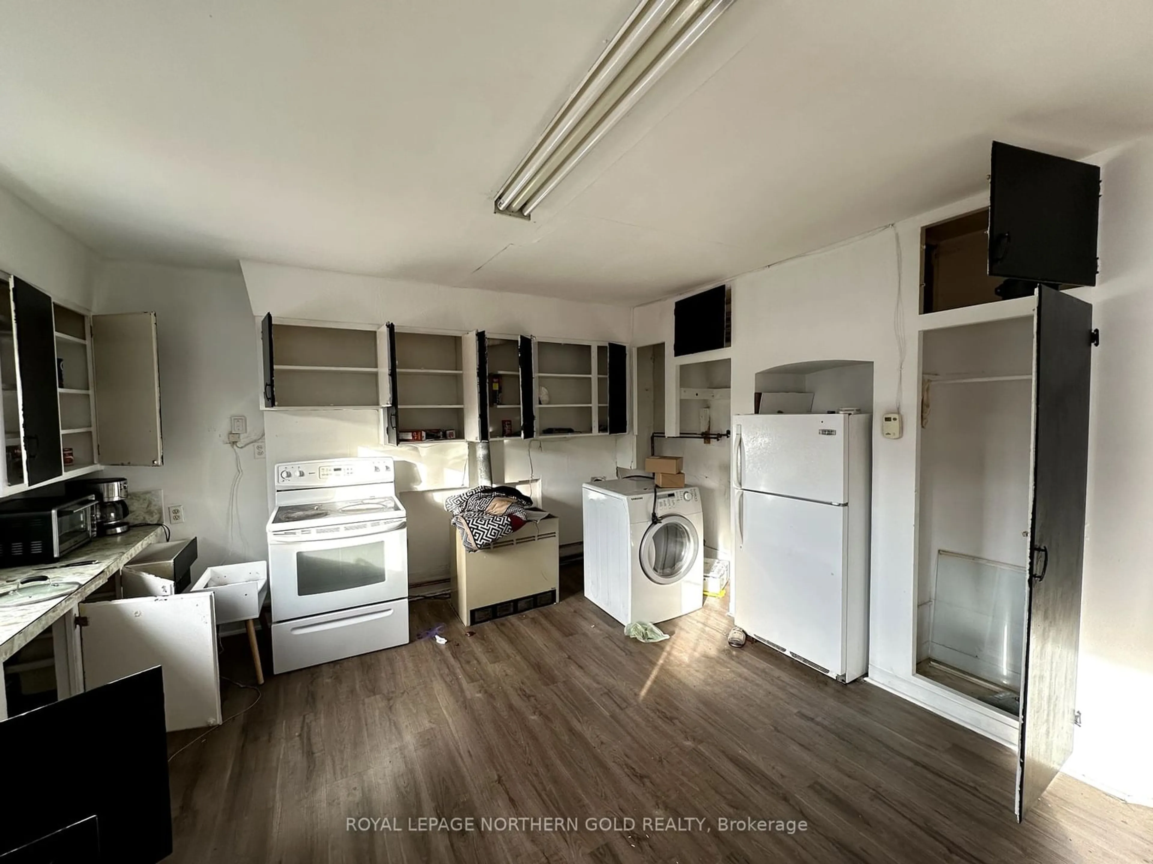 Kitchen with laundary machines, wood floors for 25 McCamus Ave, Kirkland Lake Ontario P2N 2J6