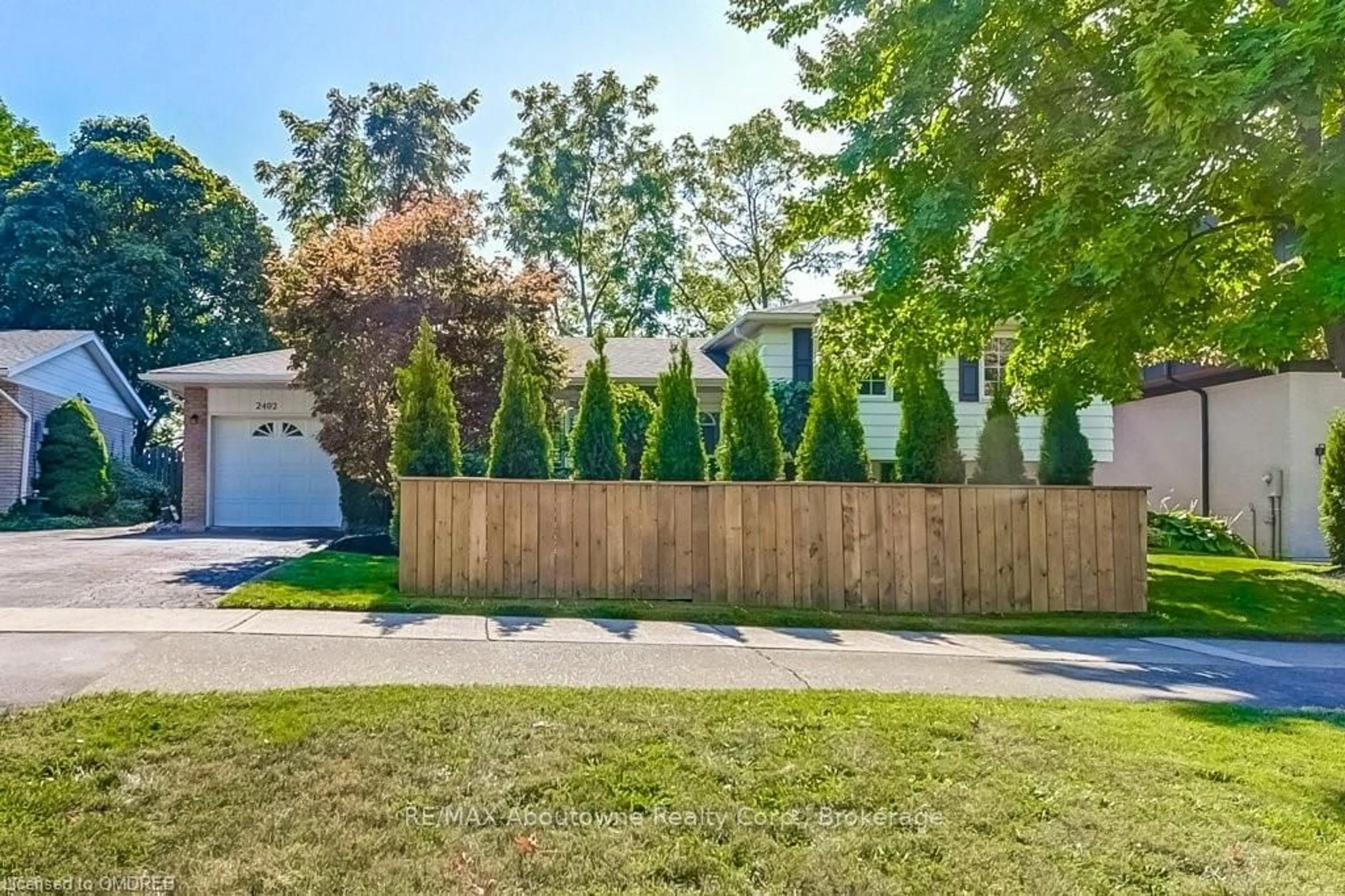 Frontside or backside of a home, the fenced backyard for 2492 REBECCA St, Oakville Ontario L6L 2B2