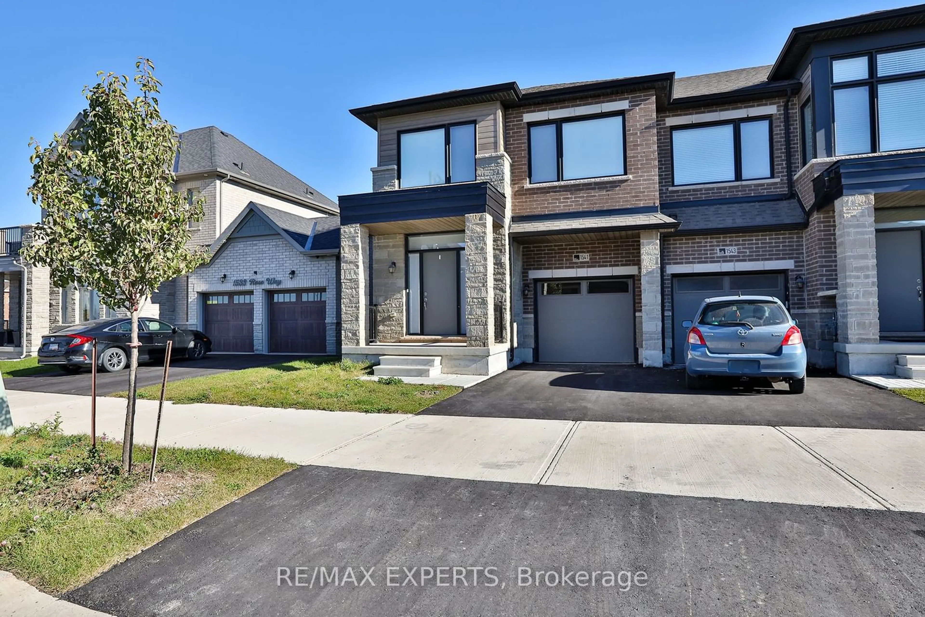 Frontside or backside of a home, the street view for 1541 Rose Way, Milton Ontario L9E 1V7