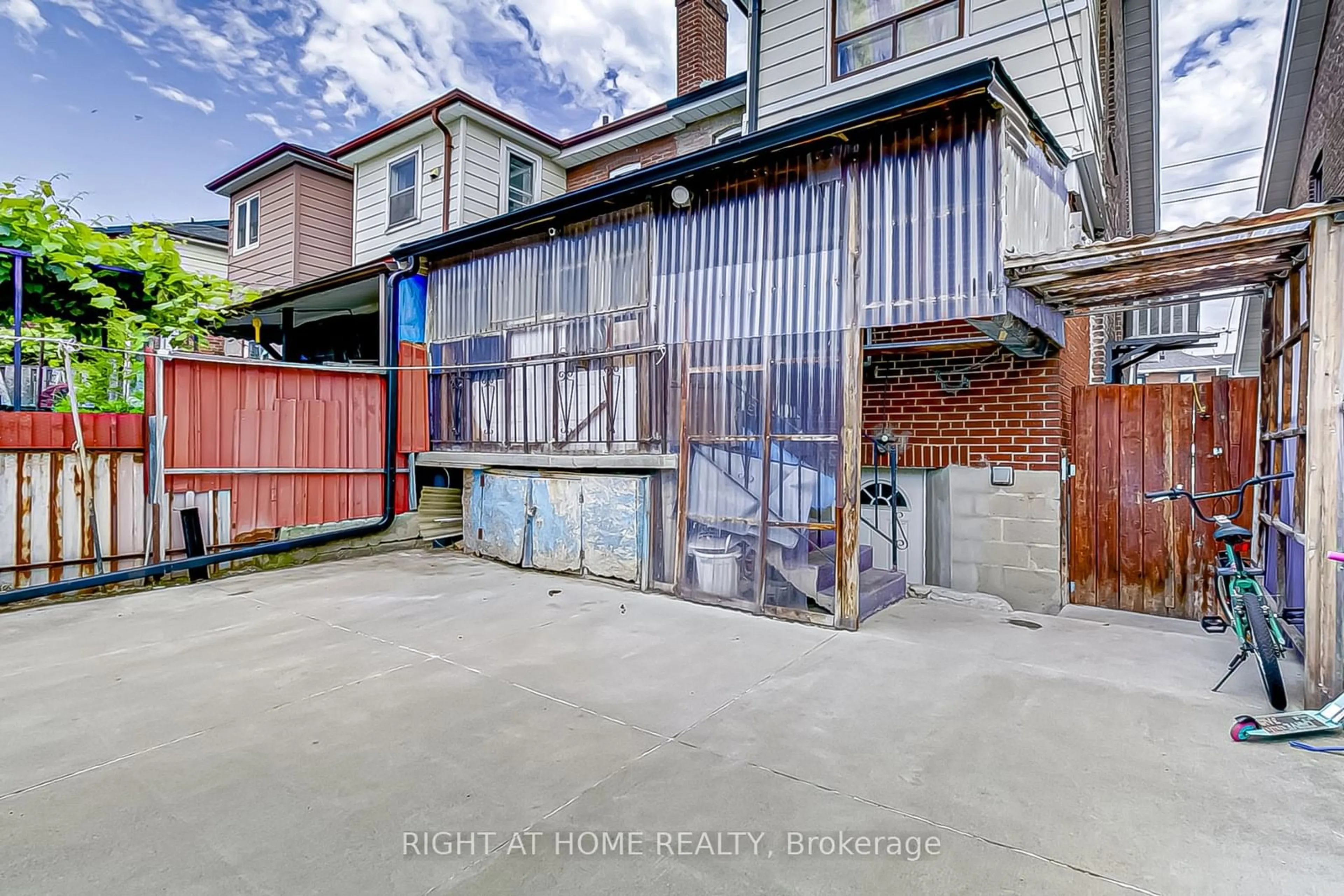 A pic from exterior of the house or condo, the fenced backyard for 1994 Dufferin St, Toronto Ontario M6E 3R2