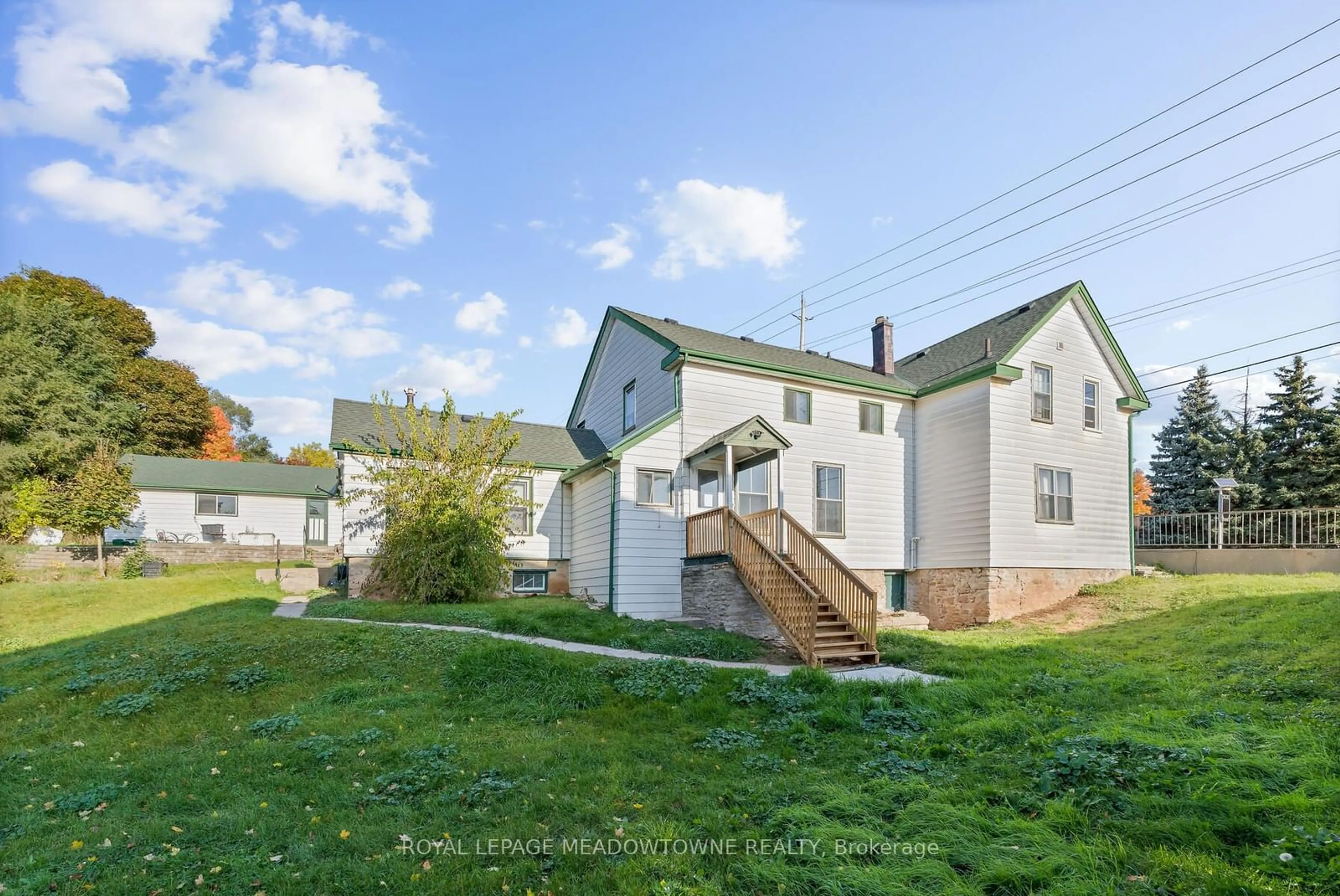 A pic from exterior of the house or condo, the fenced backyard for 20-24 Main St, Halton Hills Ontario L7G 3G8