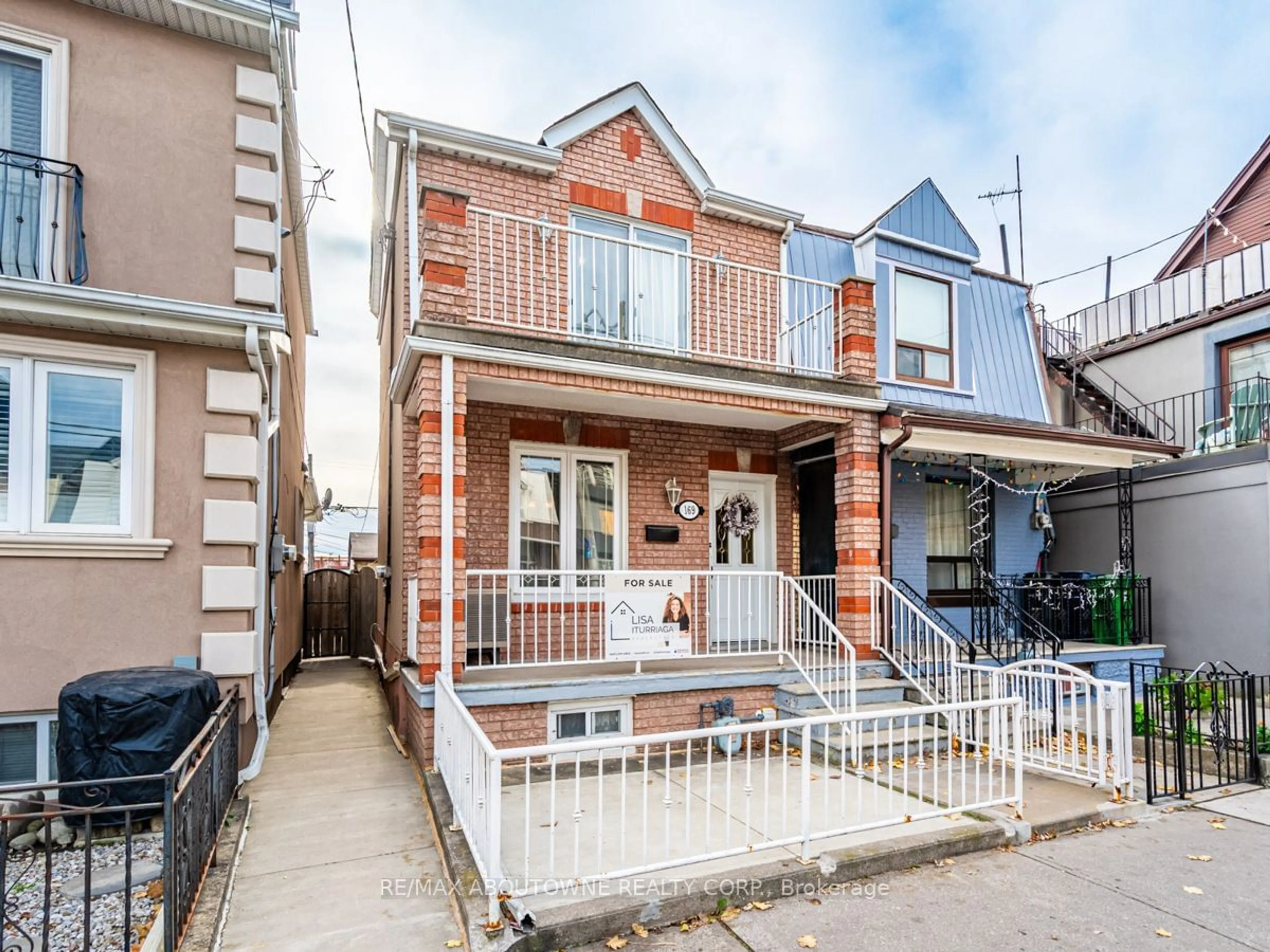 A pic from exterior of the house or condo, the fenced backyard for 169 Lappin Ave, Toronto Ontario M6H 1Y7