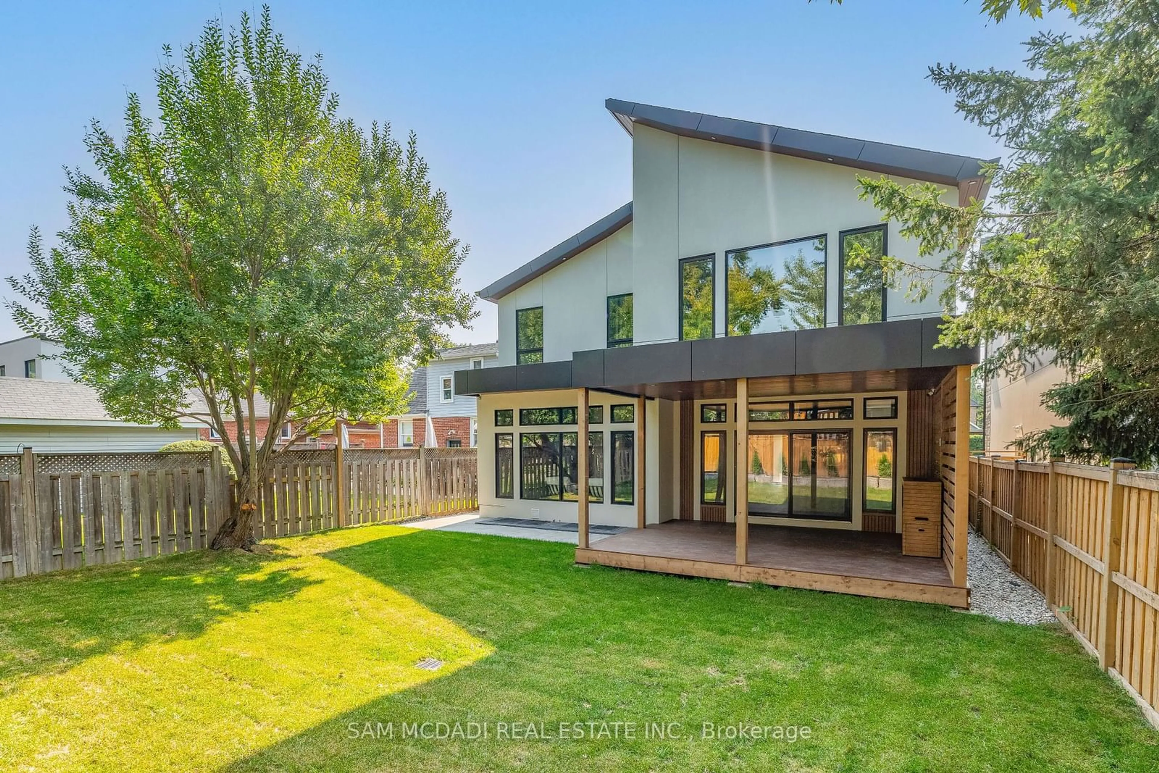 Frontside or backside of a home, the fenced backyard for 32 Swan Ave, Toronto Ontario M9B 1V4