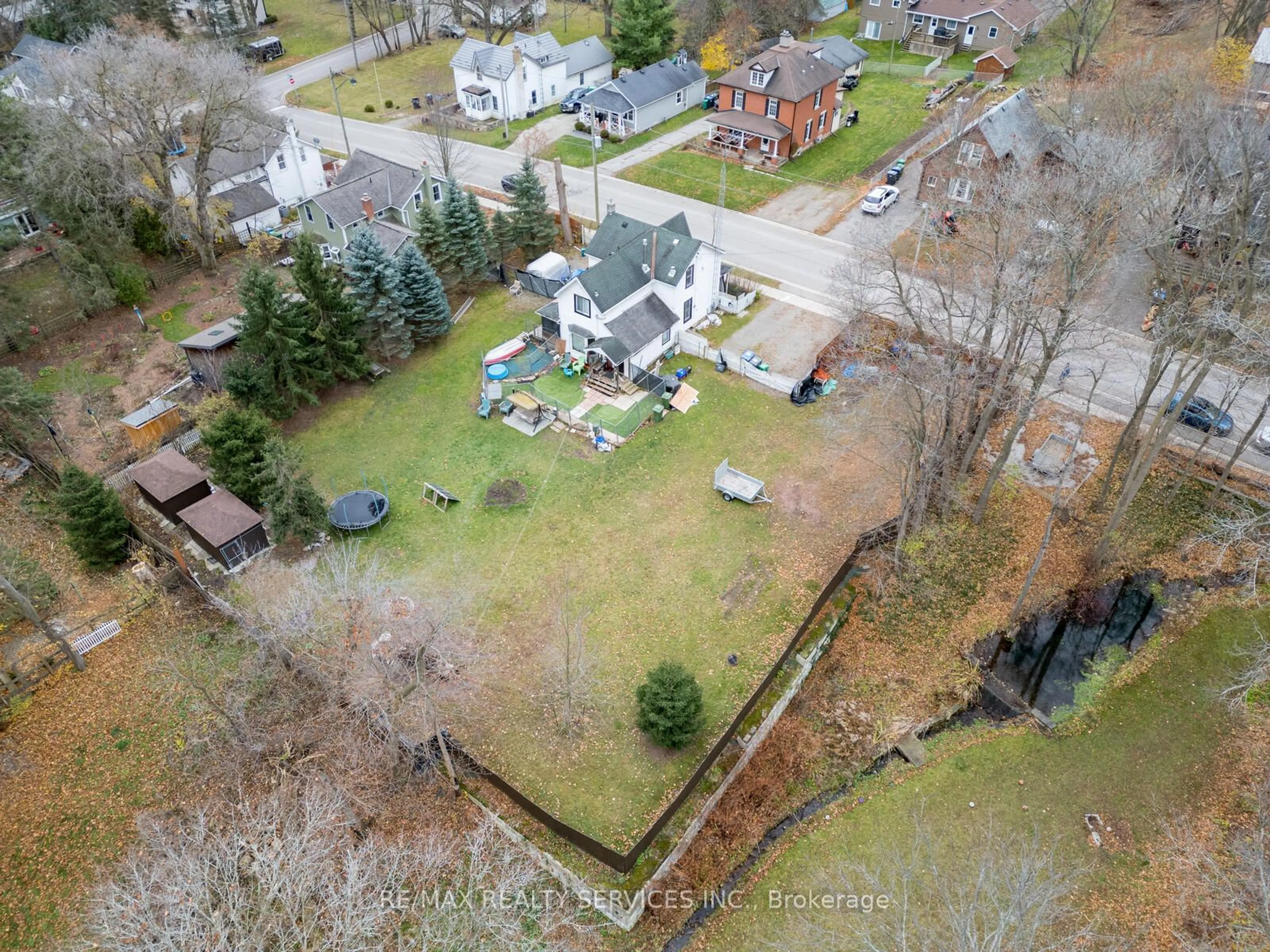 Frontside or backside of a home, the fenced backyard for 25 Lorne St, Caledon Ontario L7C 1L2