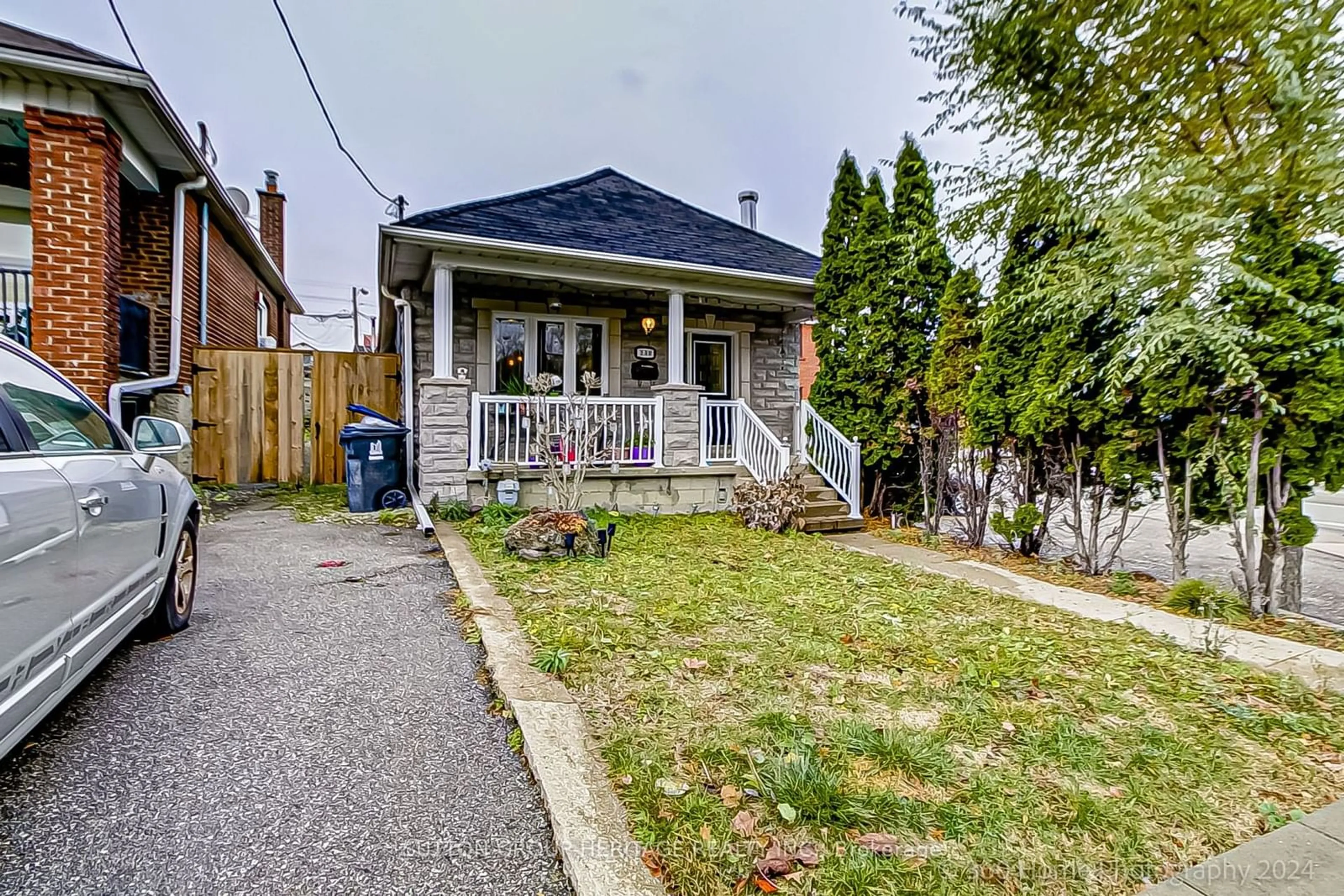 Frontside or backside of a home, the fenced backyard for 230 Gilbert Ave, Toronto Ontario M6E 4W5