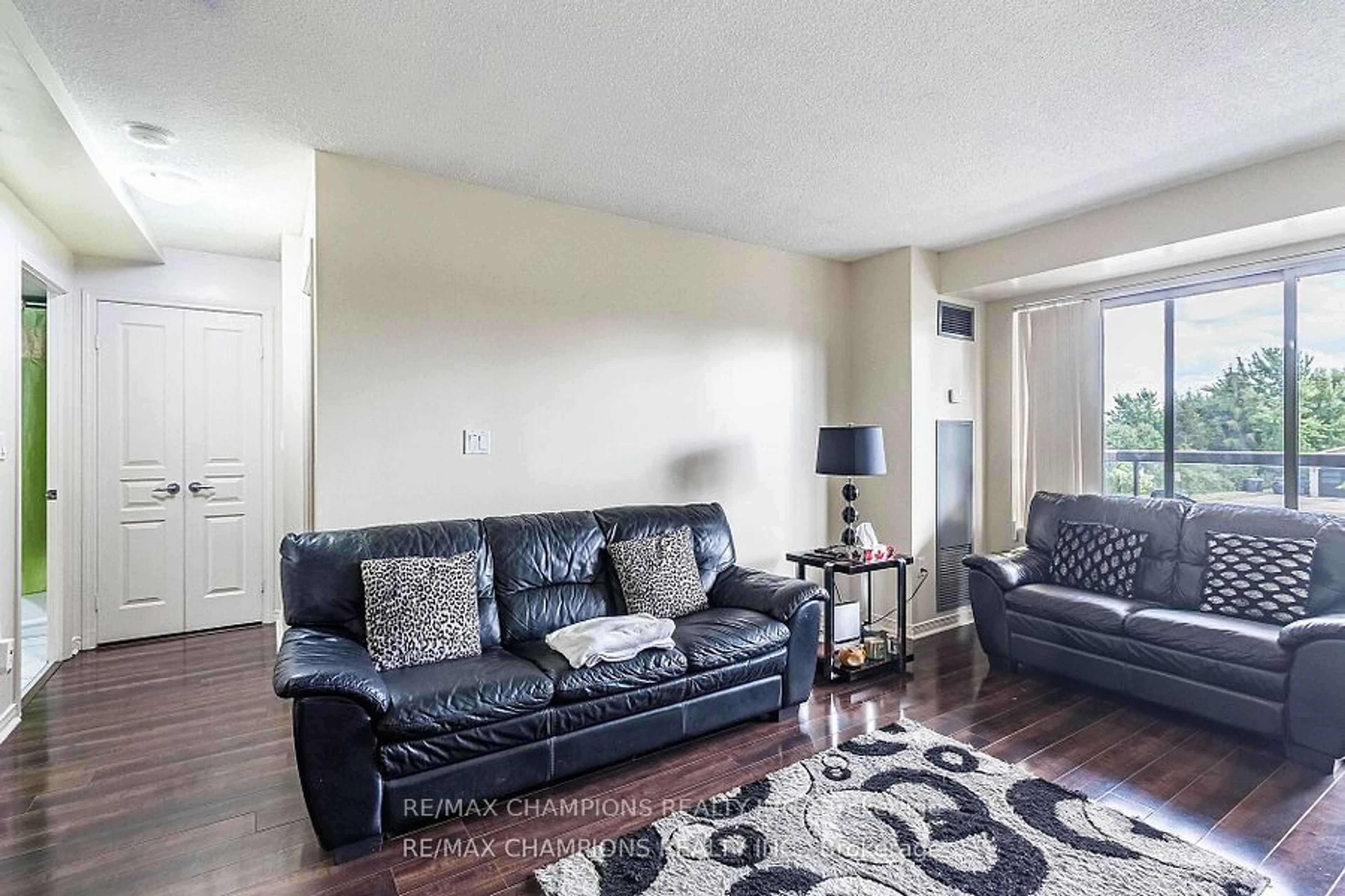 Living room, carpet floors for 300 Ray Lawson Blvd #216, Brampton Ontario L6Y 5H5