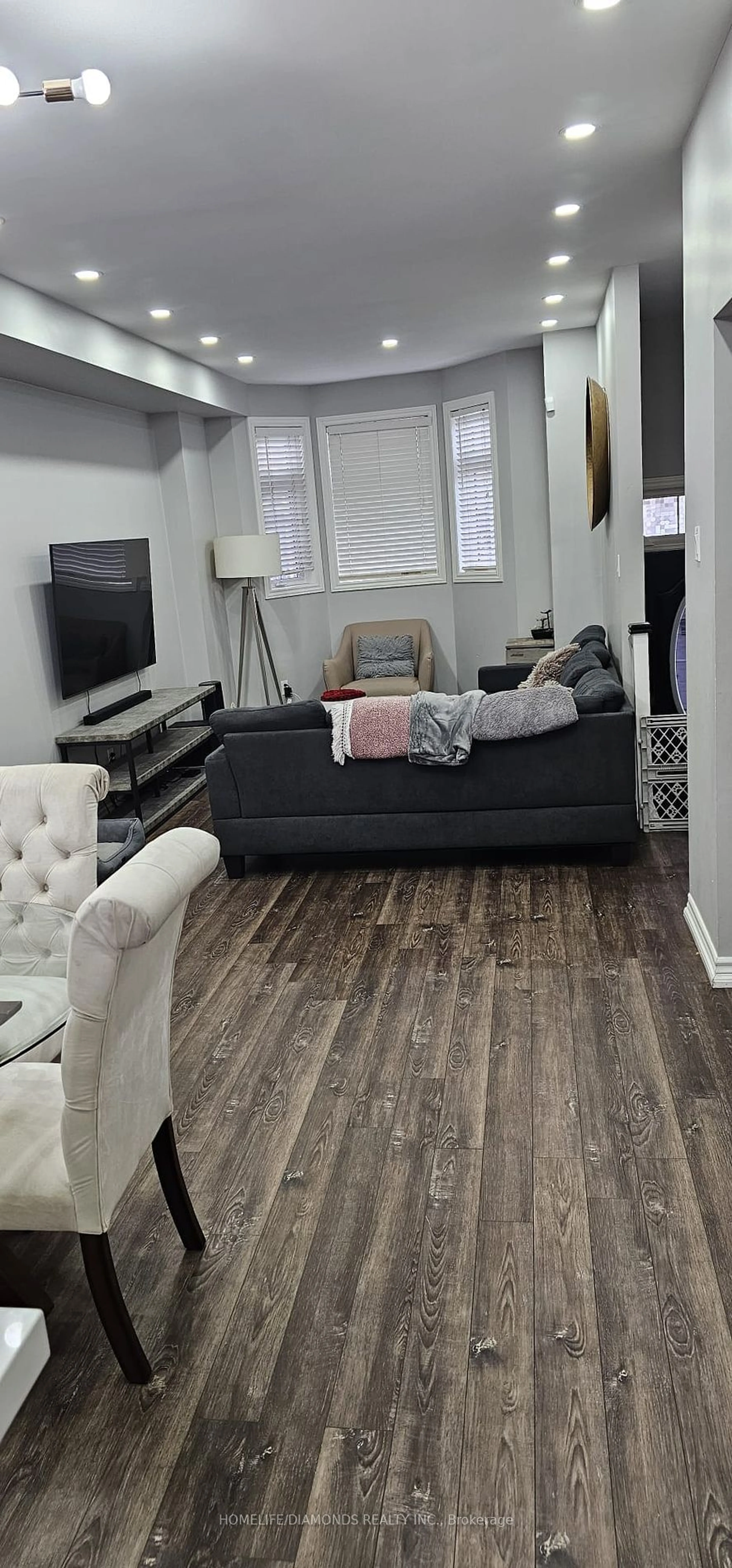 Living room with furniture, wood/laminate floor for 16 Piggott Mews, Toronto Ontario M9N 0A4