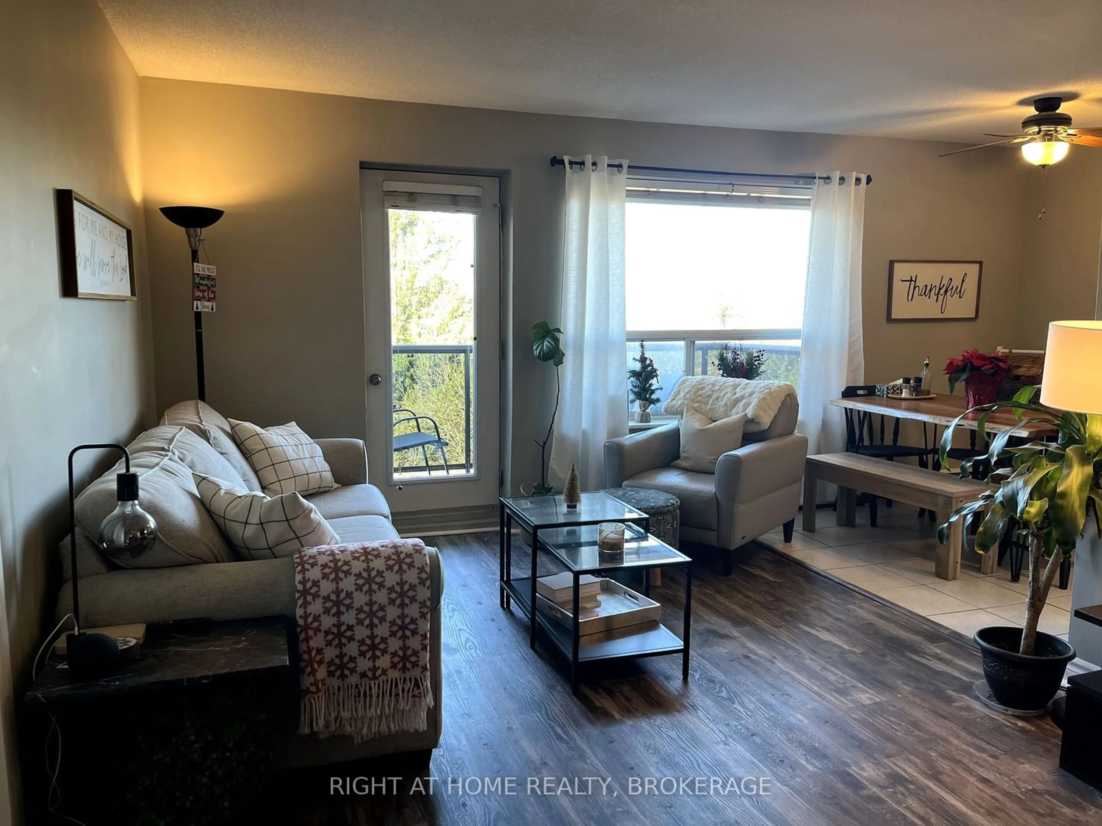 Living room with furniture, wood/laminate floor for 2411 New St #604, Burlington Ontario L7R 1K2