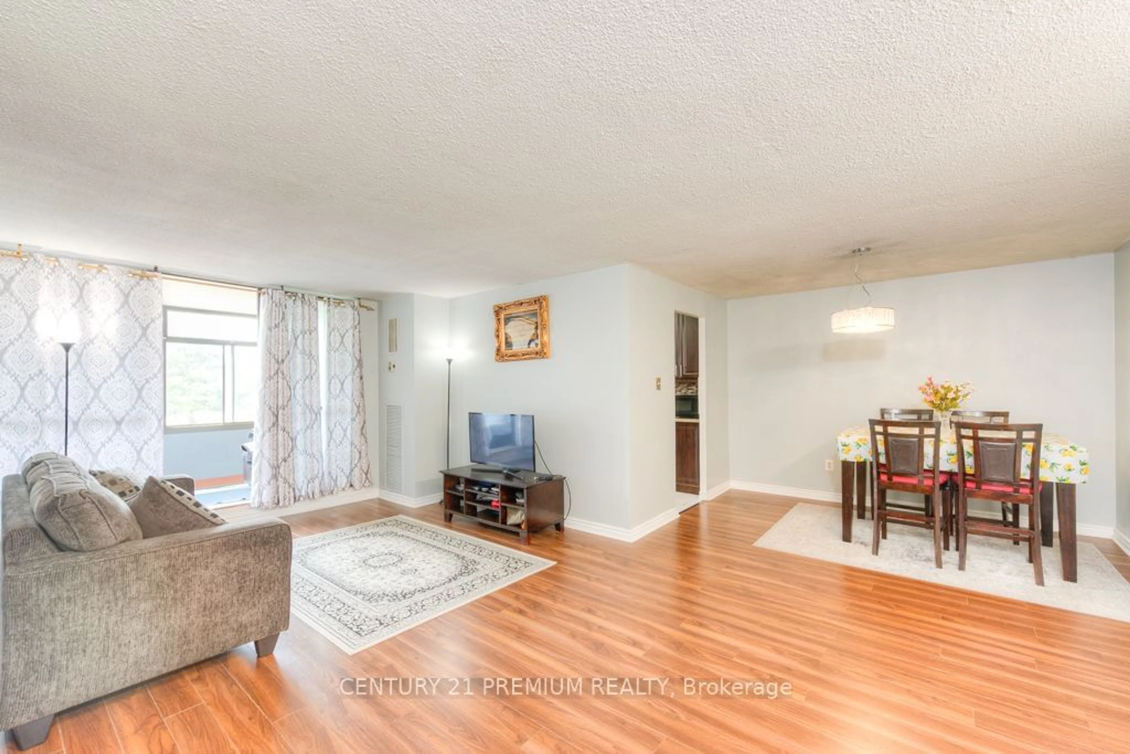 Living room with furniture, wood/laminate floor for 15 Kensington Rd #204, Brampton Ontario L6T 3W2