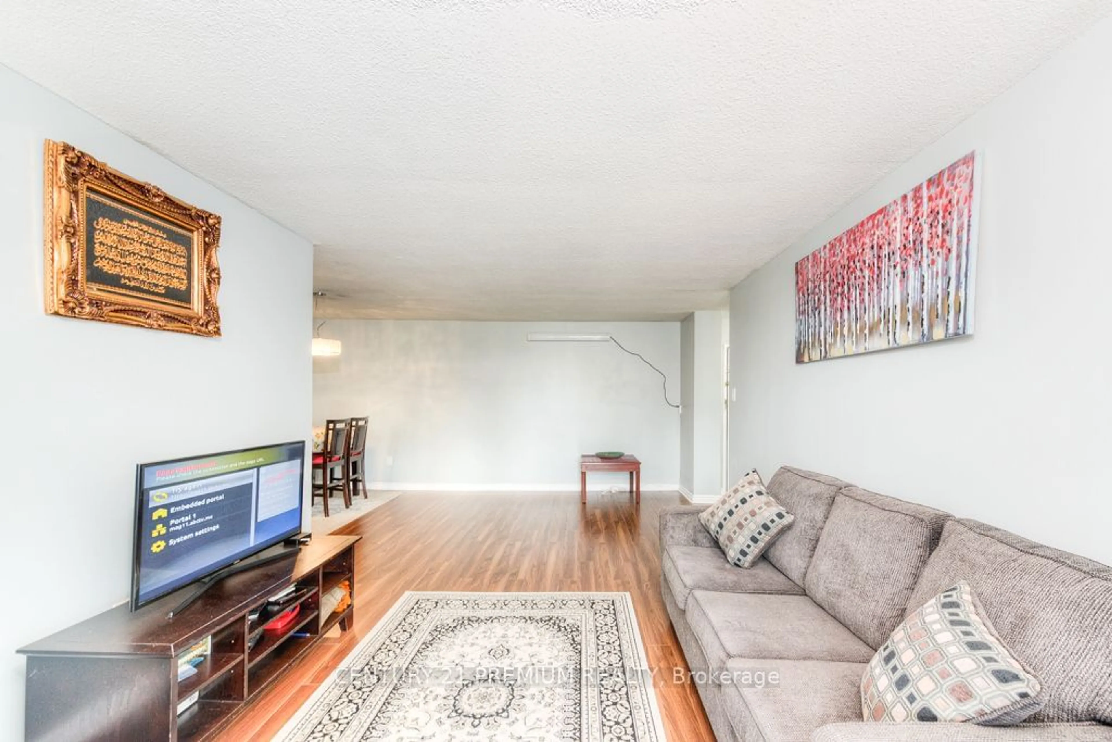 Living room with furniture, wood/laminate floor for 15 Kensington Rd #204, Brampton Ontario L6T 3W2