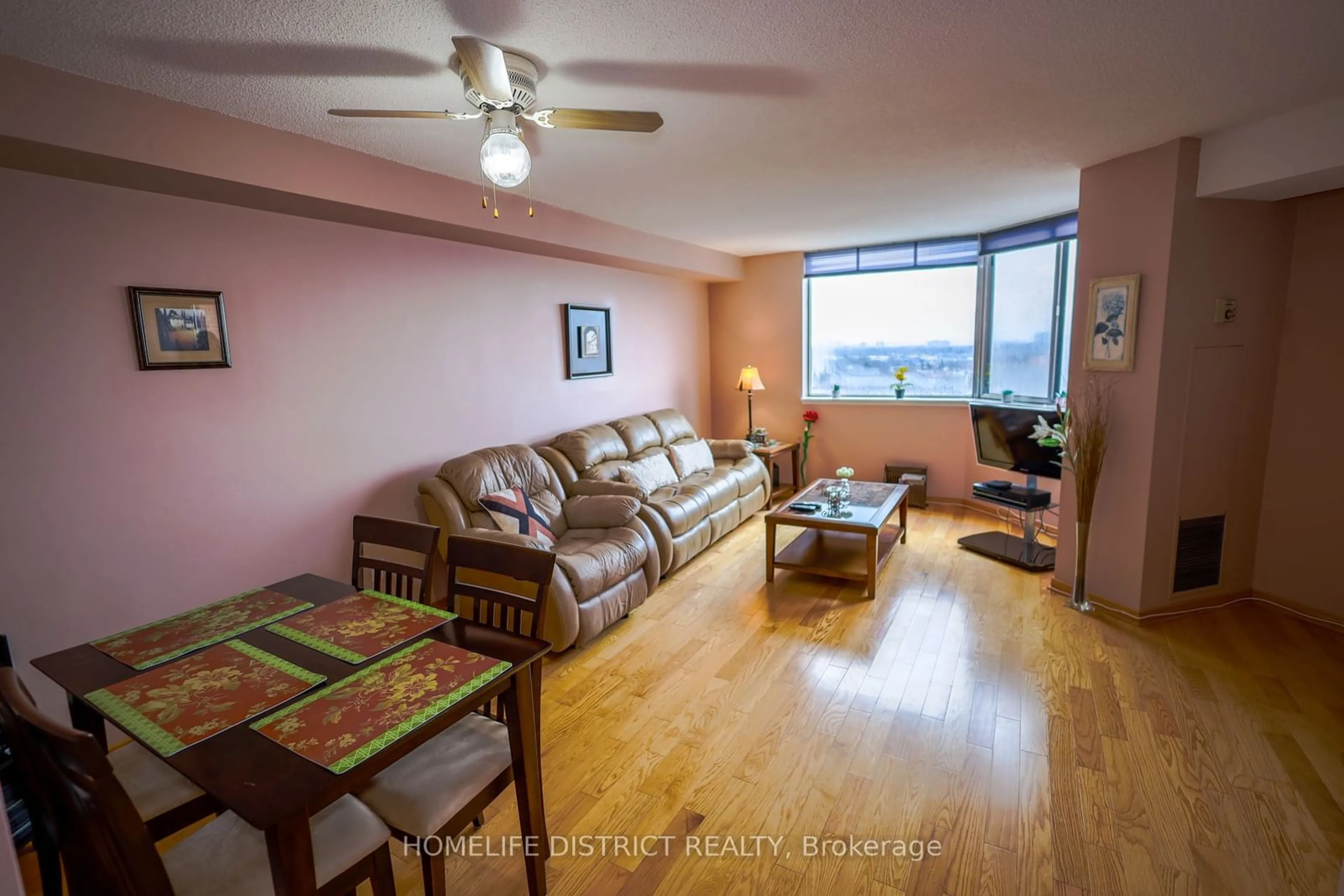 Living room with furniture, wood/laminate floor for 234 Albion Rd #1902, Toronto Ontario M9W 6A5