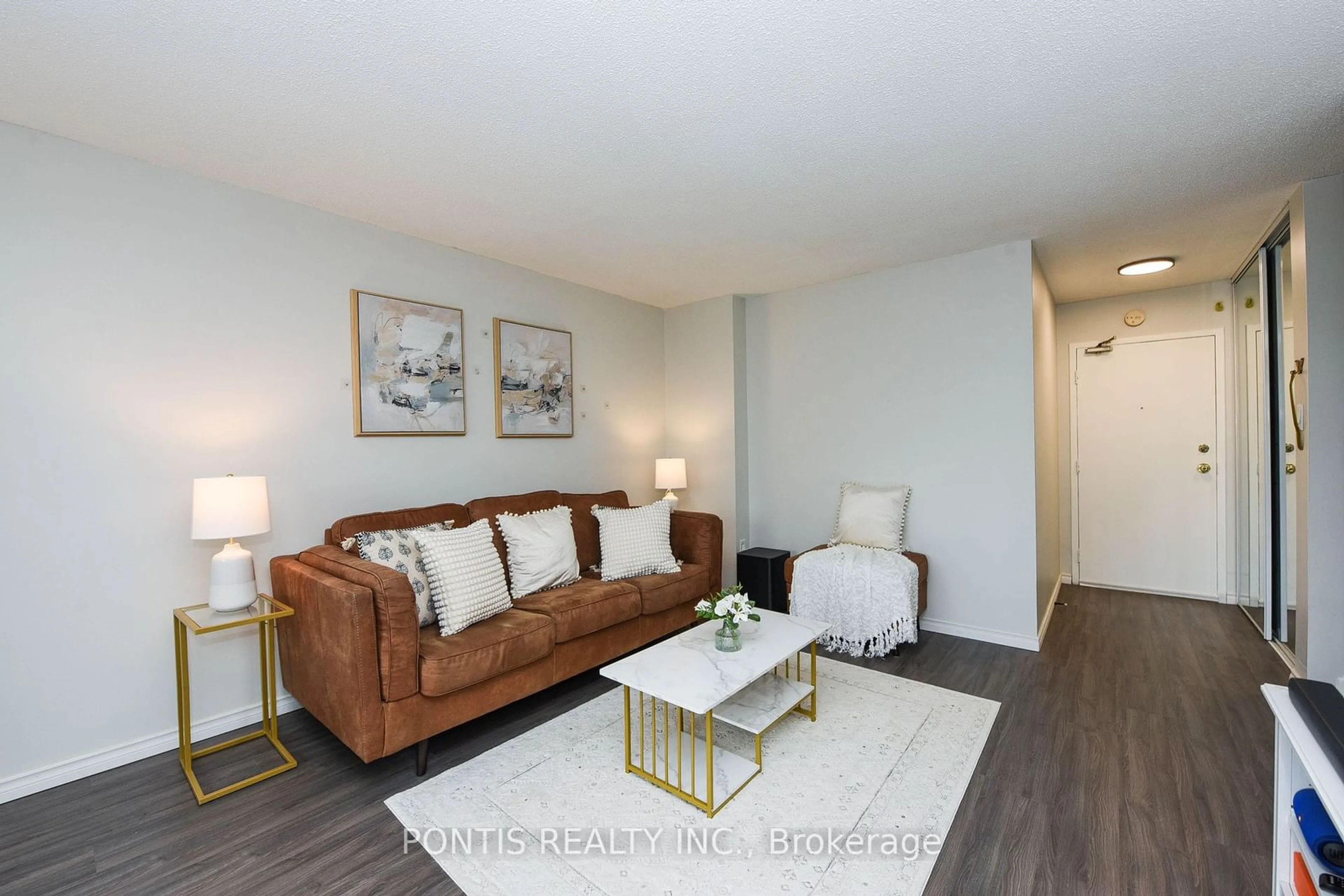 Living room with furniture, wood/laminate floor for 2001 Bonnymede Dr #214, Mississauga Ontario L5J 4H8