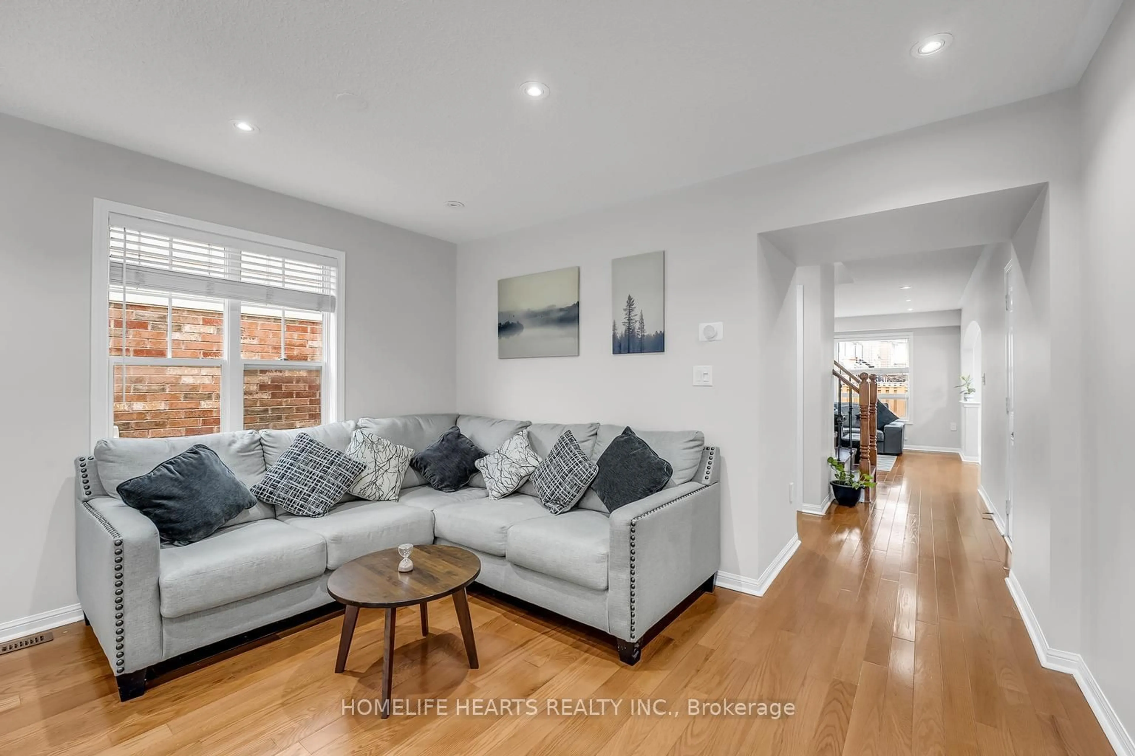 Living room with furniture, wood/laminate floor for 101 Owlridge Dr, Brampton Ontario L6X 0M7