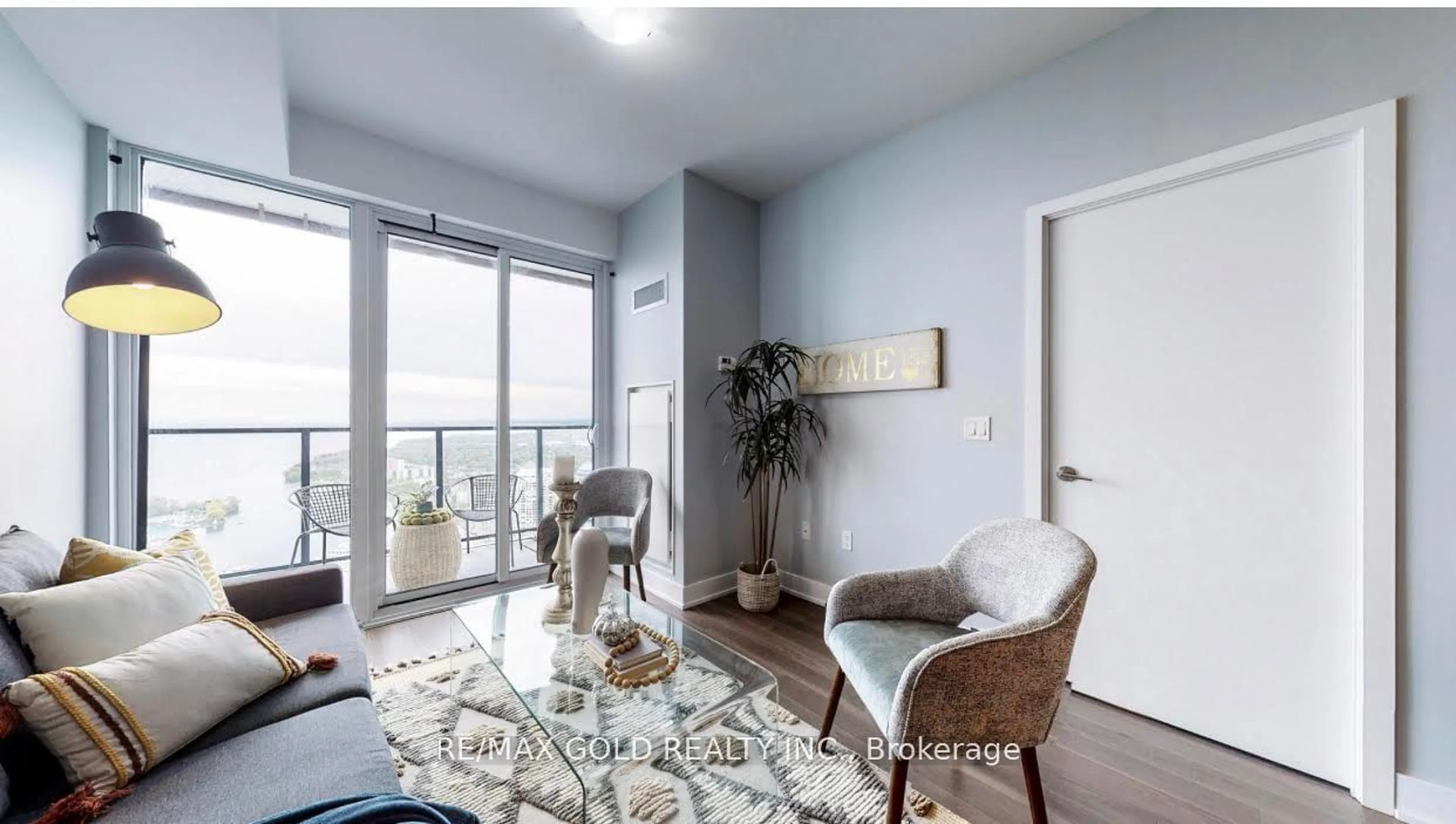 Living room with furniture, wood/laminate floor for 30 Shore Breeze Dr #4816, Toronto Ontario M8V 0J1