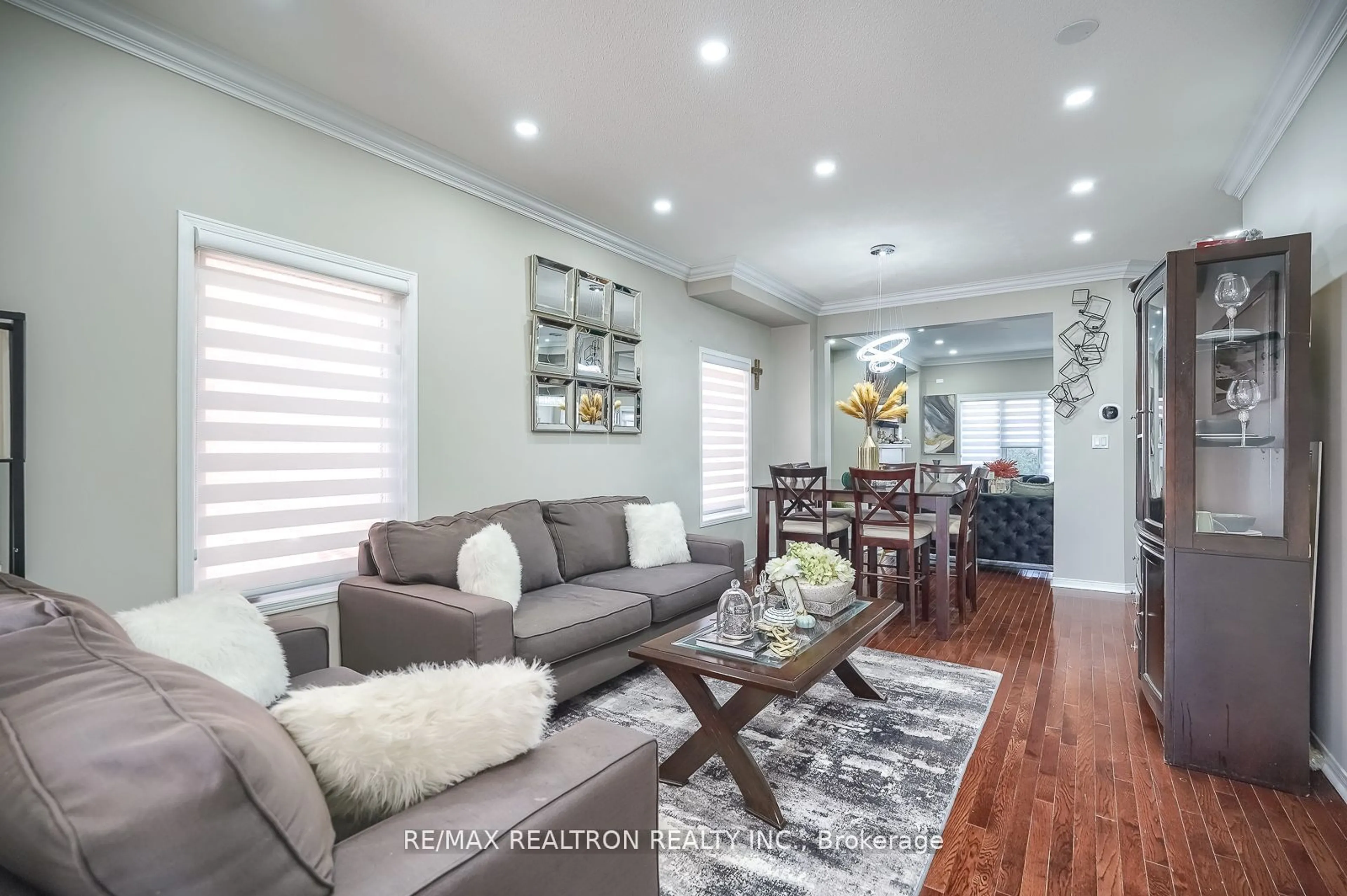 Living room with furniture, wood/laminate floor for 102 Commodore Dr, Brampton Ontario L6X 0T4